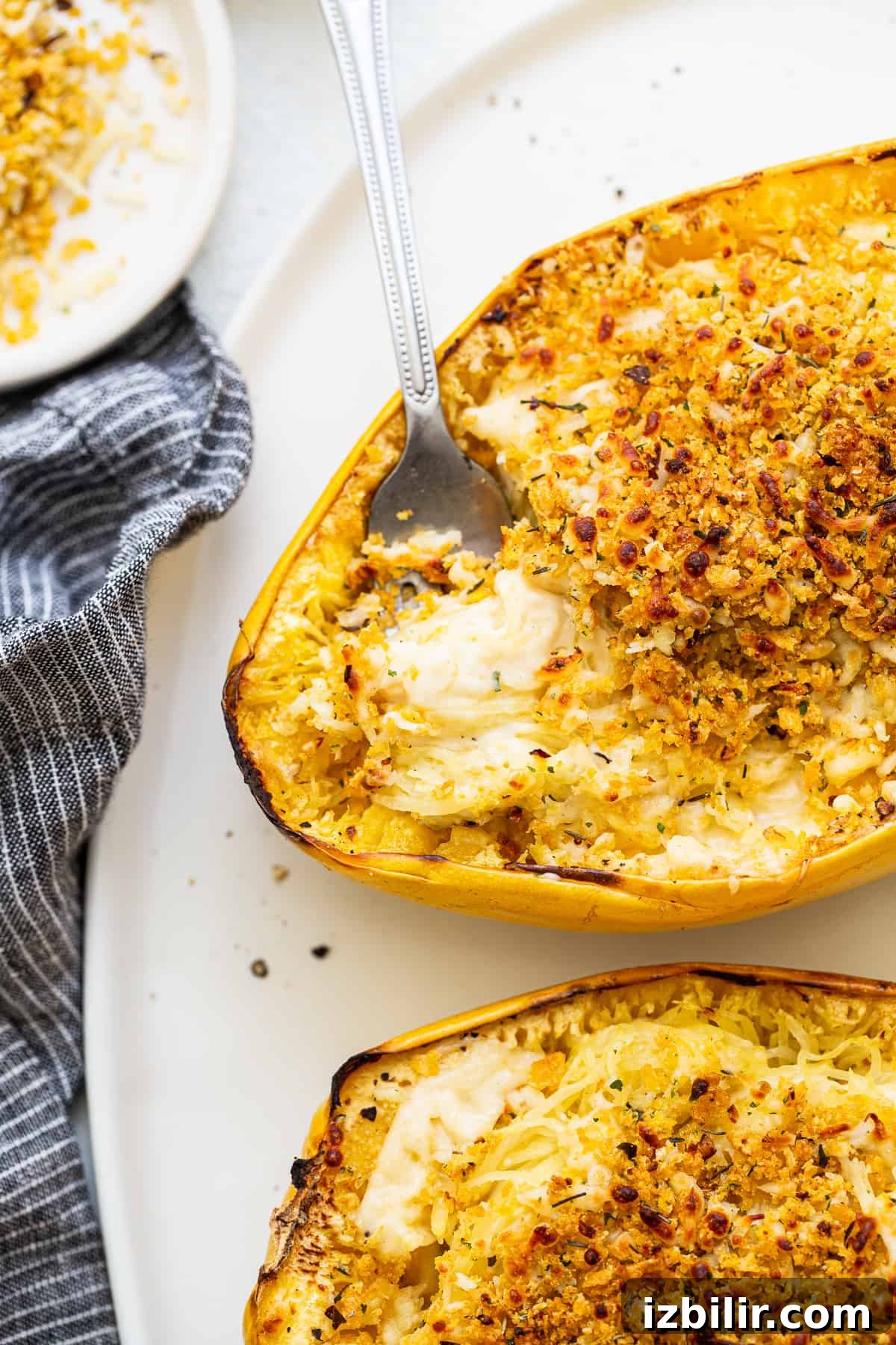 Spaghetti squash mac and cheese Spaghetti squash mac and cheese with a fork.