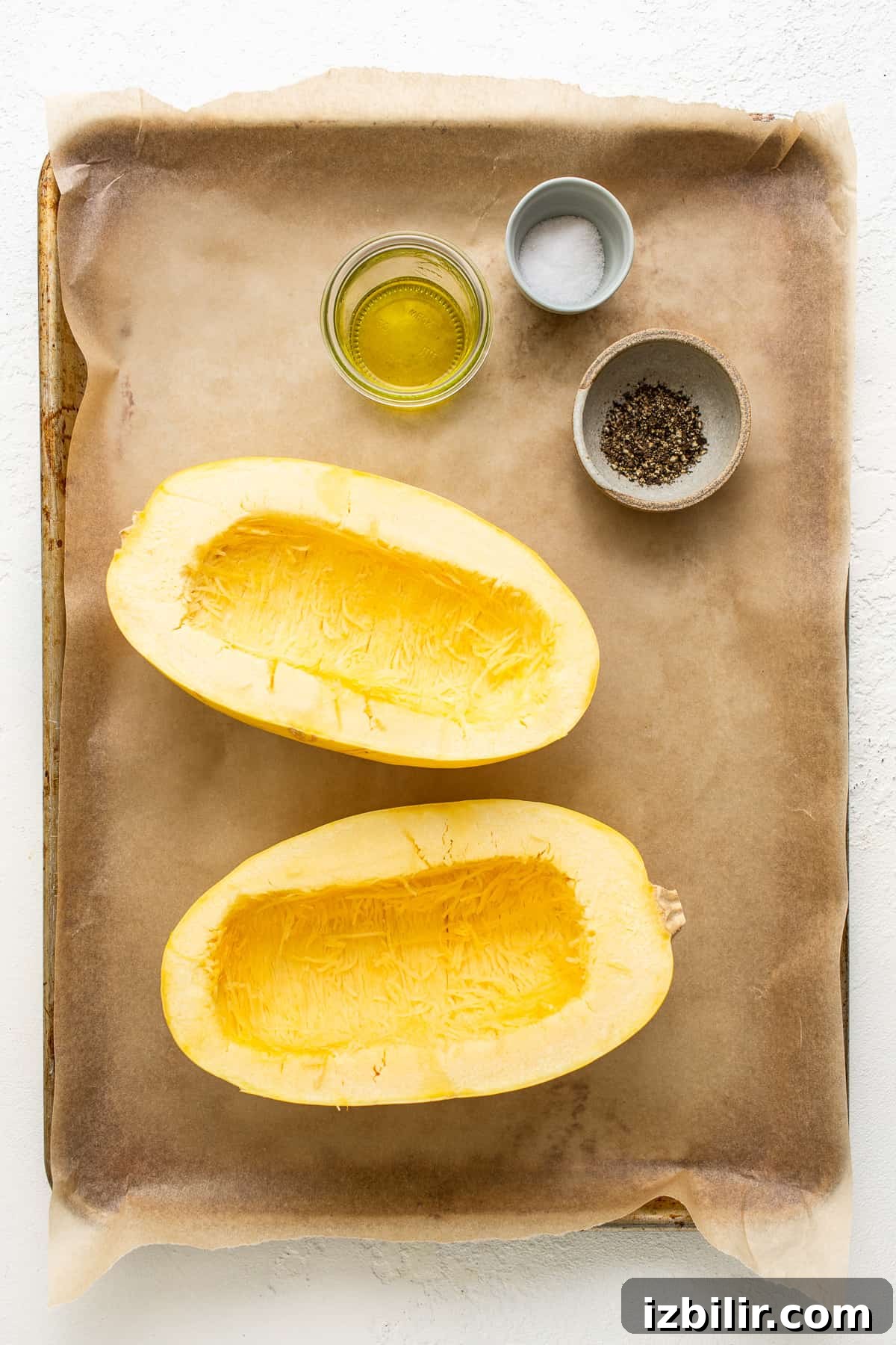 Ingredients laid out for spaghetti squash mac and cheese Spaghetti squash mac and cheese ingredients on a baking sheet.