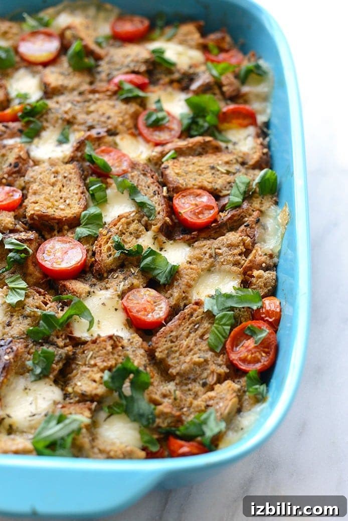 Close-up of a Caprese-style egg bake with melted cheese and tomatoes.