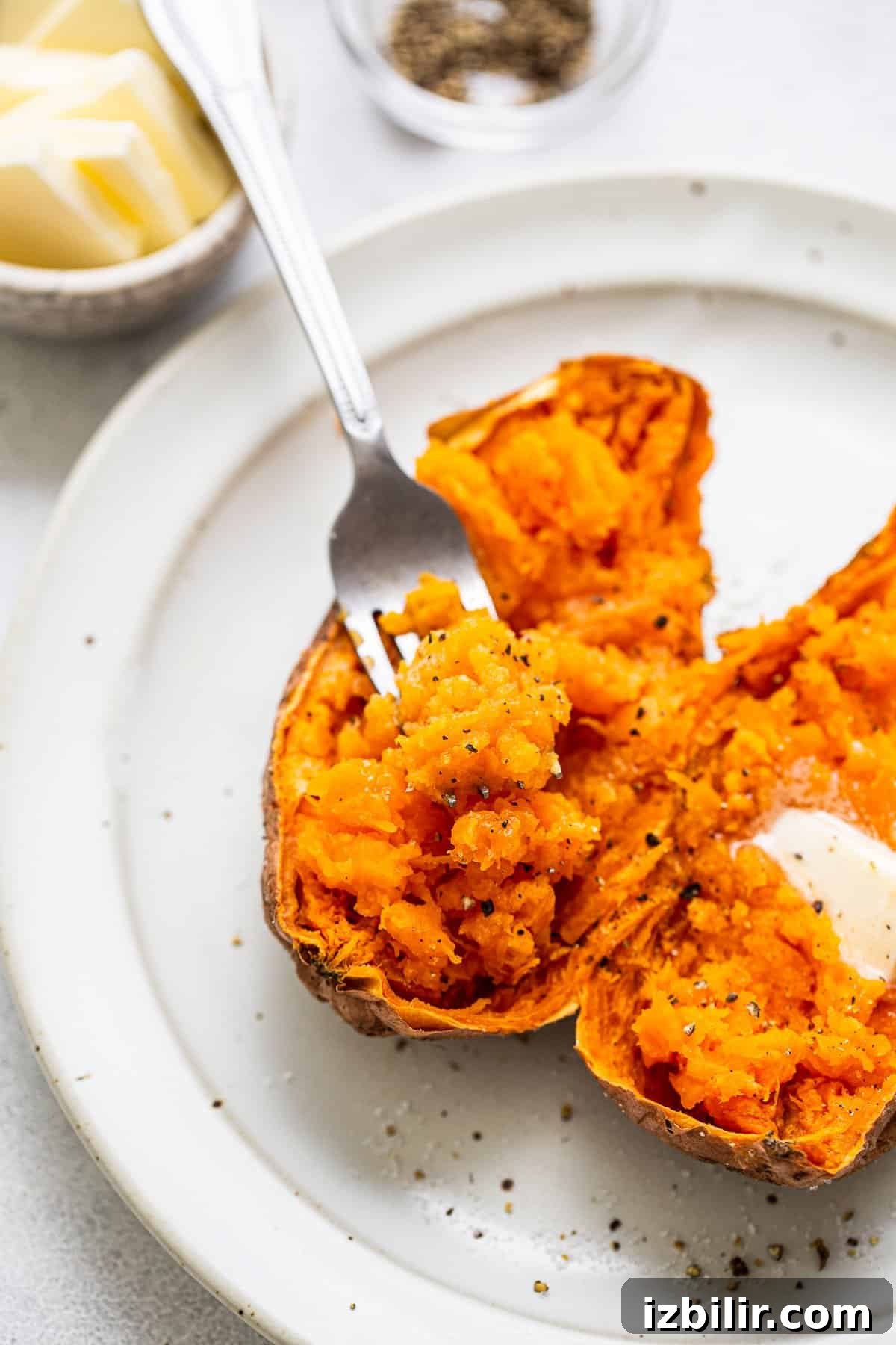 Microwave Sweet Potato to Tender Perfection 7 A fork scooping out the middle of a sweet potato.
