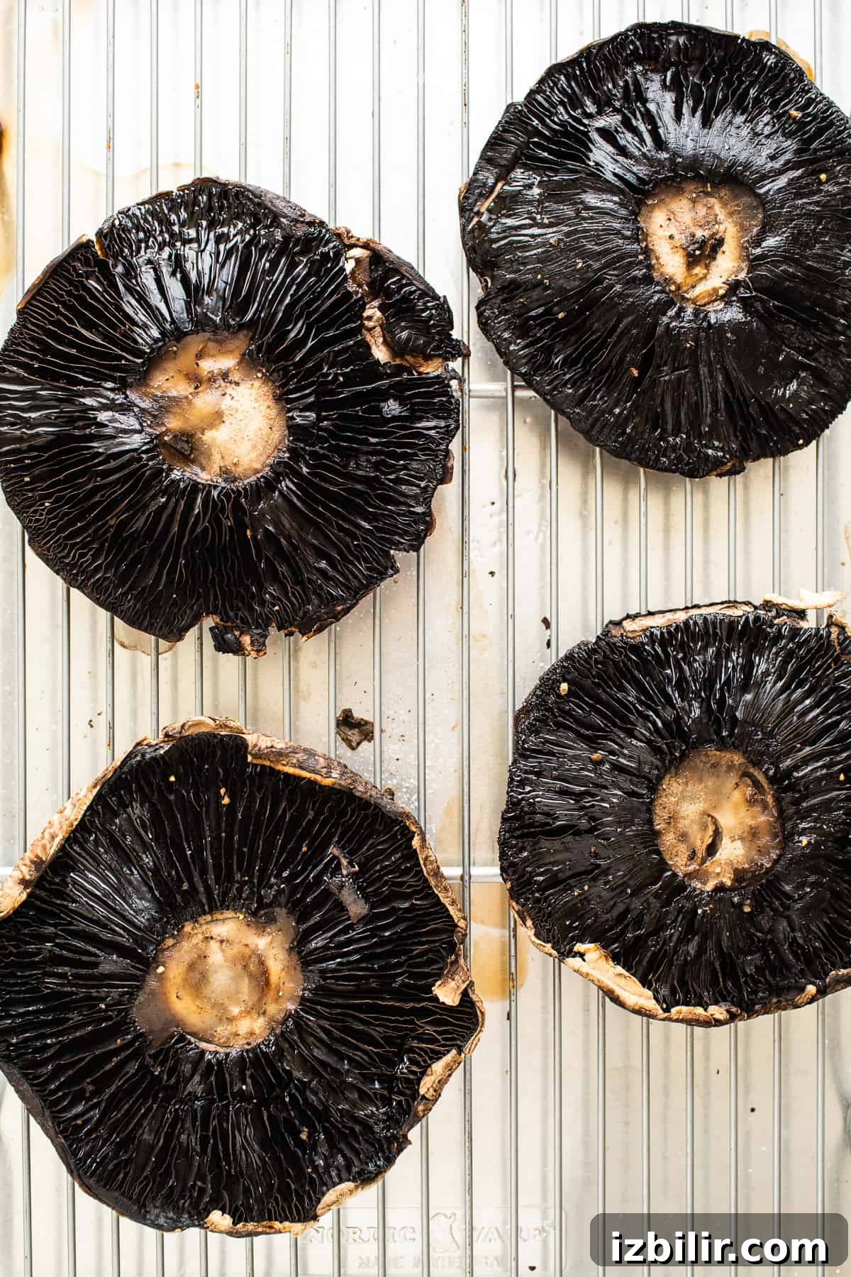 Portobello mushrooms on a baking sheet.