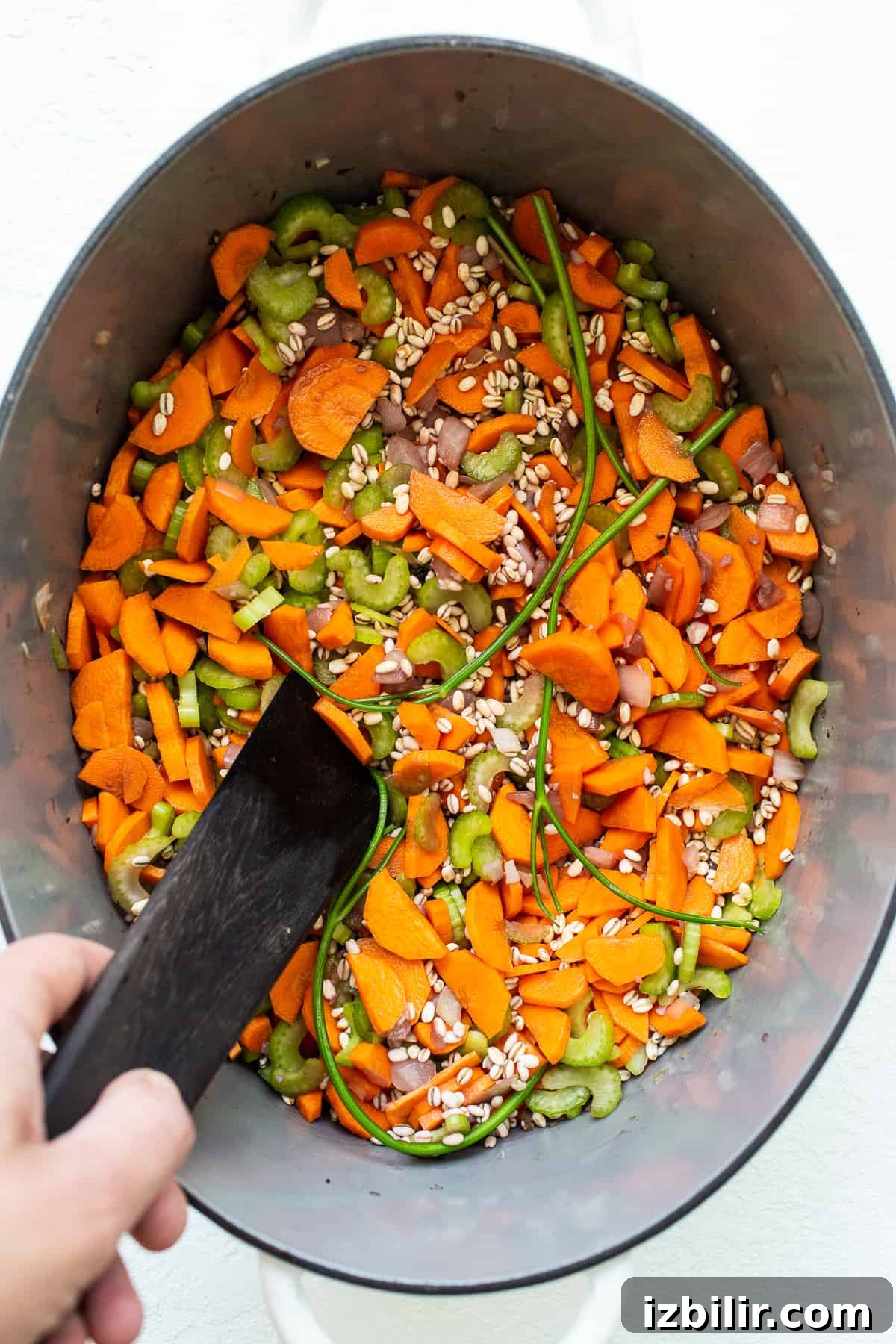 veggies and barley in pot.