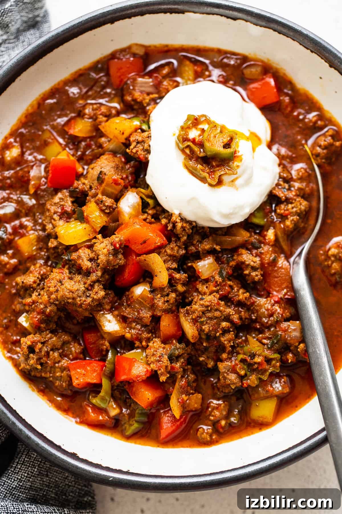 Authentic Texas Chili Recipe with Smoky, Spicy Flavor 7 Texas chili topped with sour cream in a bowl