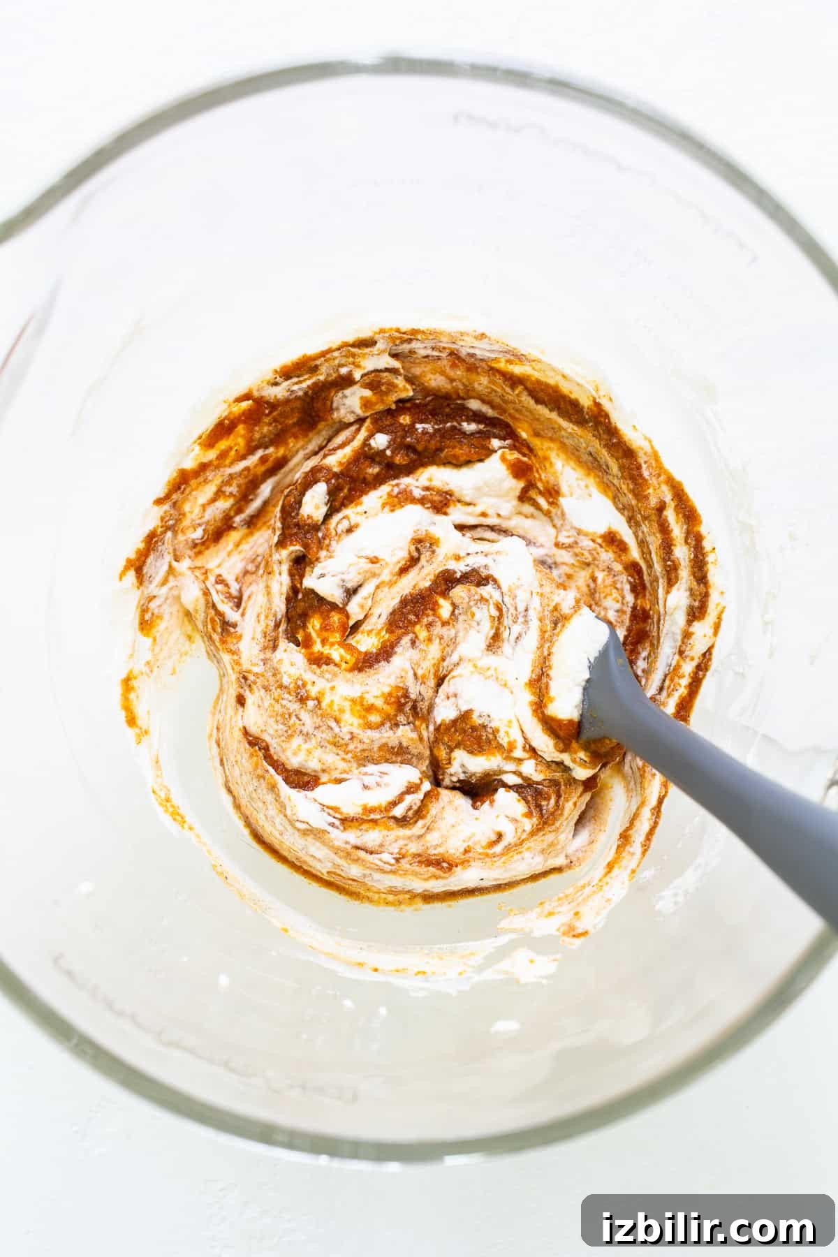 Pumpkin mixture with whipped cream for pumpkin mousse in a bowl.