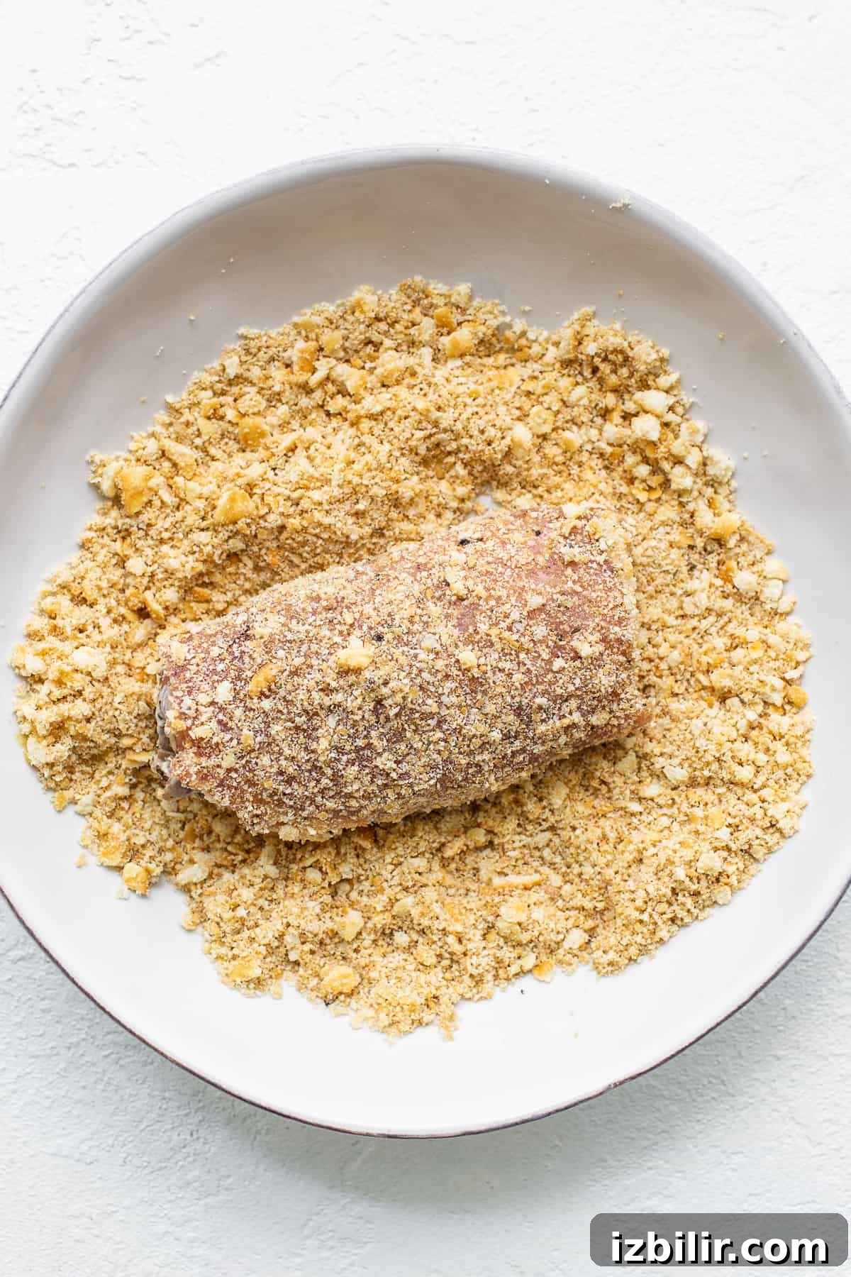 Dredging pork chops in Ritz crackers