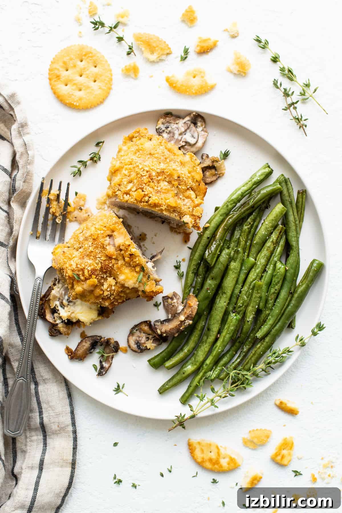 Stuffed pork chop on plate with green beans