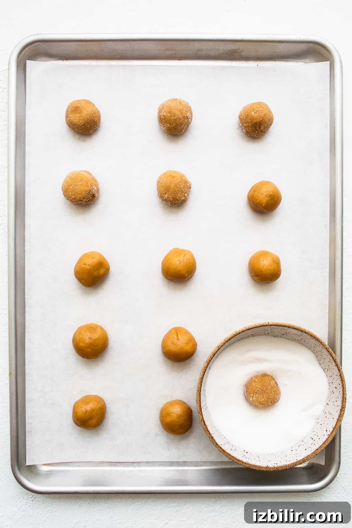 Peanut butter kiss cookies on a baking sheet.