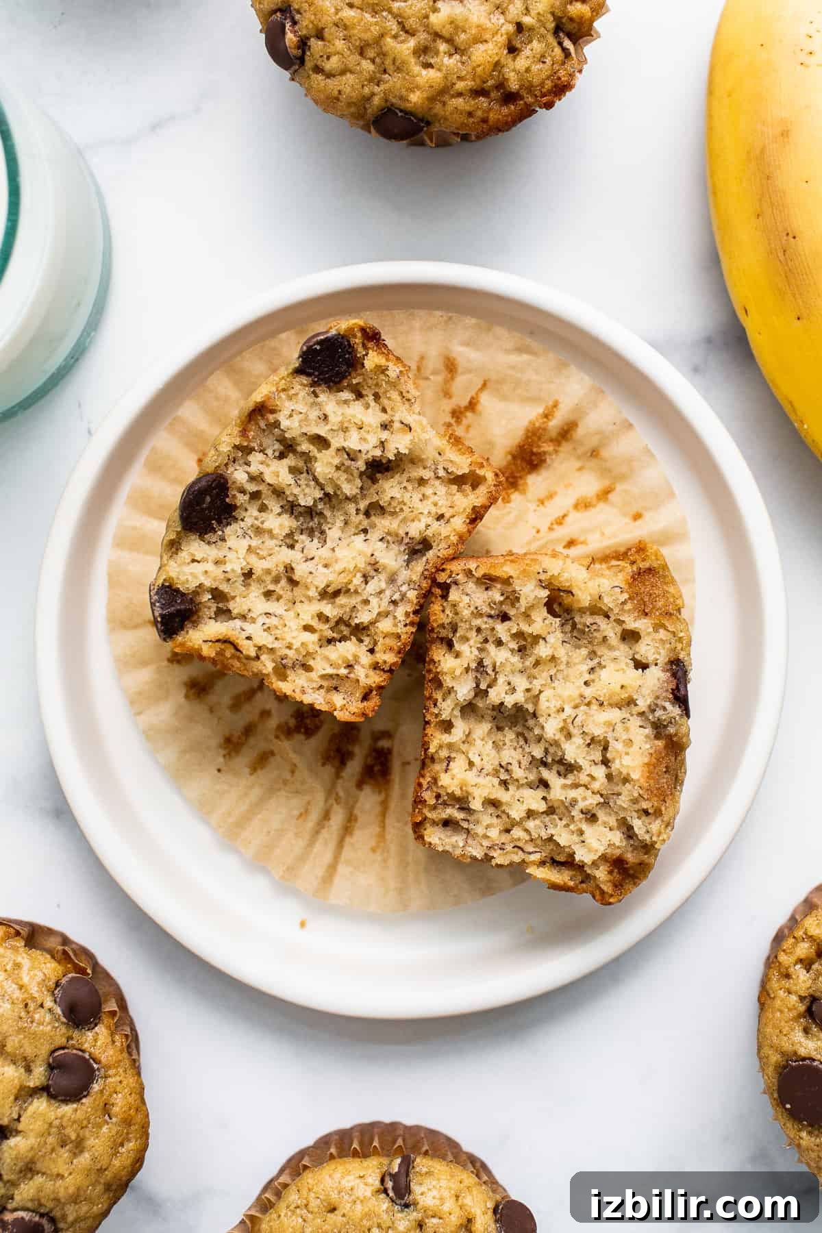 Welcome to January 2023’s edition of Fit Foodie Cooking Club — our amazing banana bread muffins! You’ll absolutely love these fluffy muffins. Banana bread muffin cut in half.