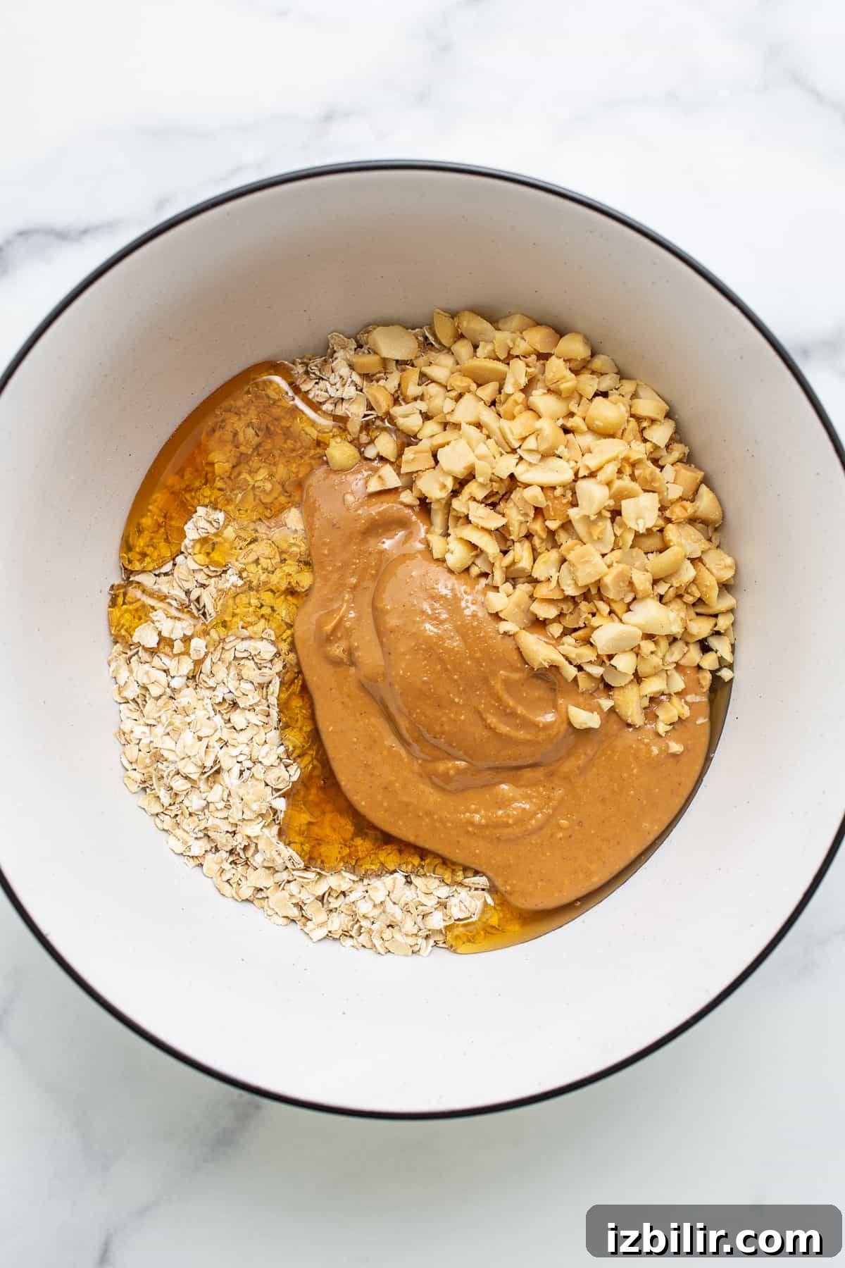 Ingredients for no-bake peanut butter oat cups Oat cup ingredients in a bowl.