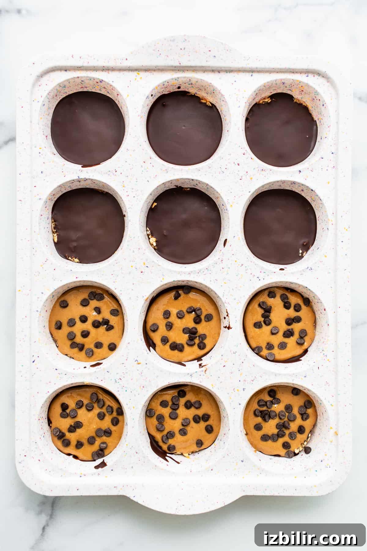 Peanut butter layer in muffin tin Peanut butter layer in muffin tin.