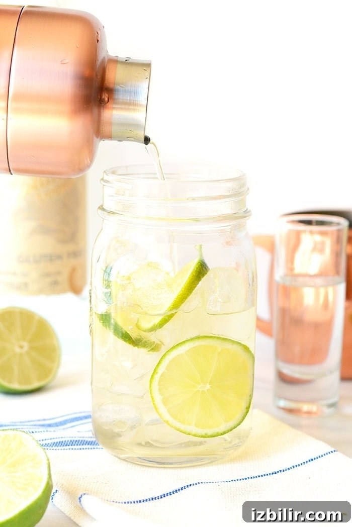With just simple 3 ingredients you can make the most delicious, flavor-filled classic Moscow mule recipe that is perfect for any time of year! pouring Moscow mule from cocktail shaker into mason jar