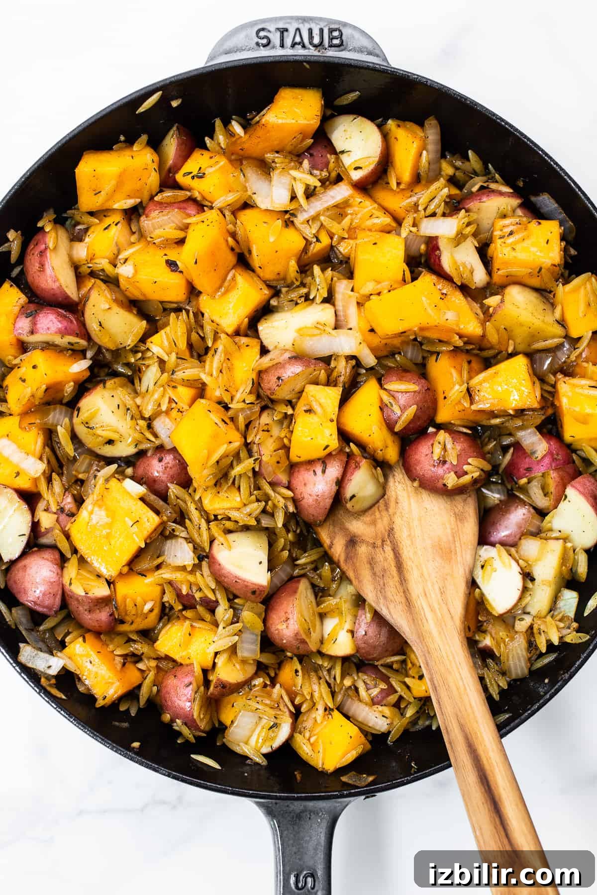 Harvest Orzo Skillet with Roasted Vegetables and Herbs 5 Orzo, butternut squash, and red potatoes in a cast iron skillet.