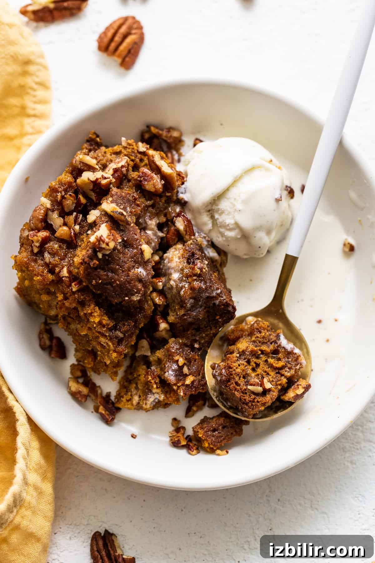 pumpkin bread pudding in bowl with ice cream.