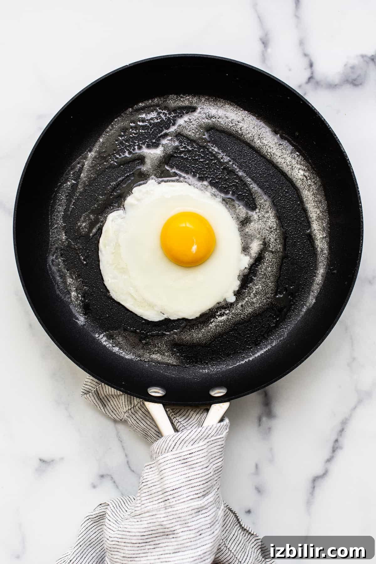 A cooked egg in a pan.