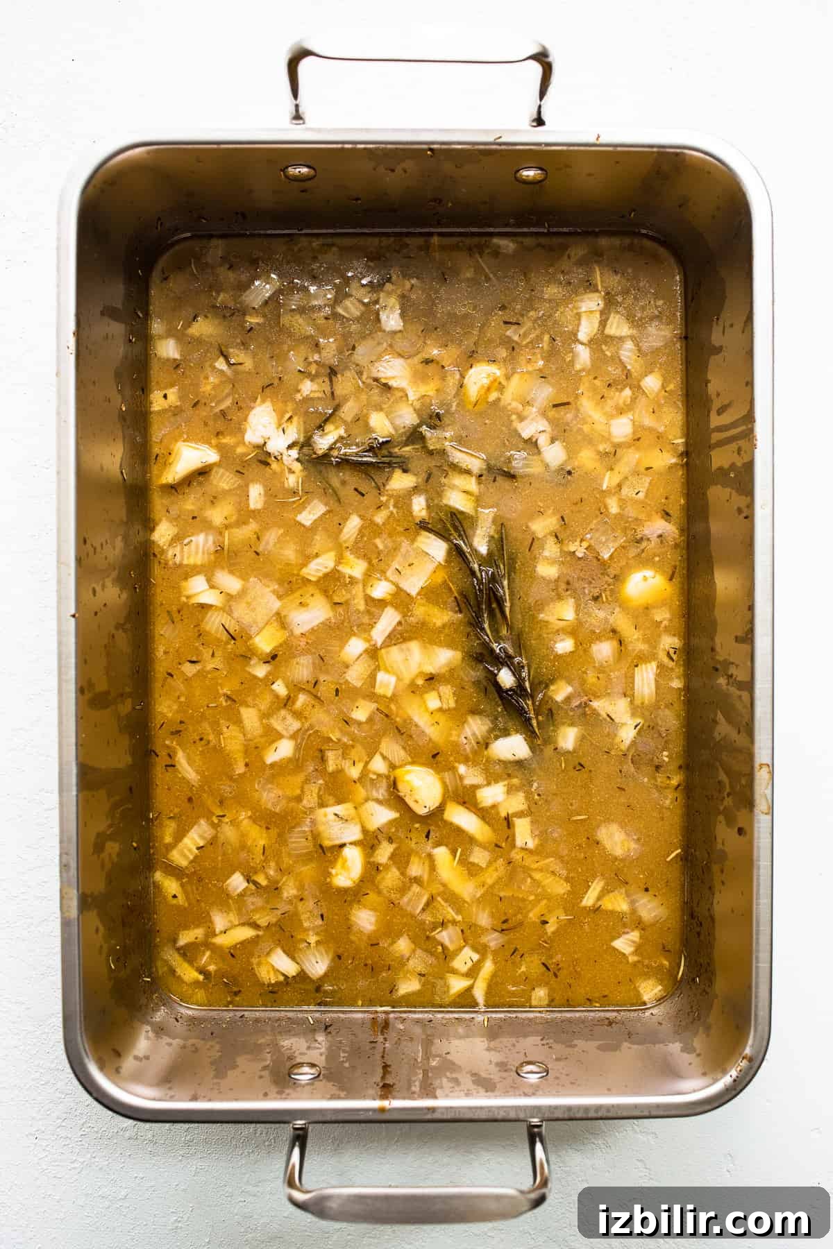 Turkey drippings in a roasting pan. Turkey drippings in a roasting pan.