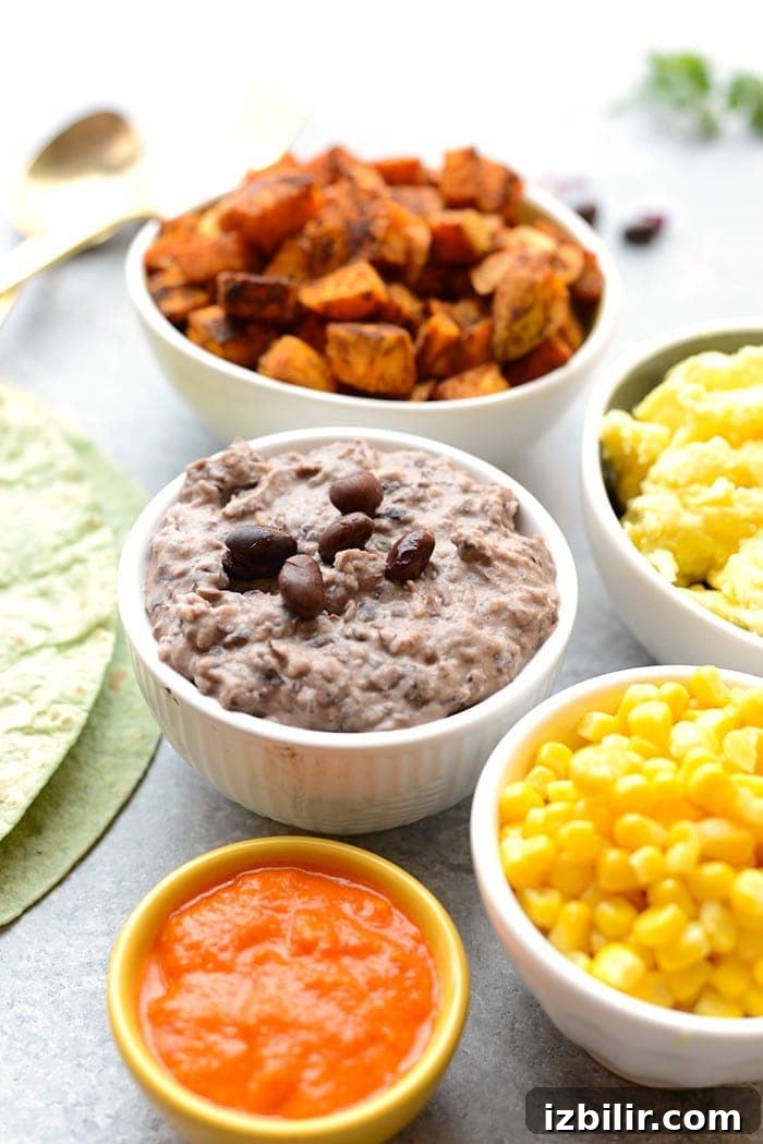 Get your meal prep on and make these Vegetarian Black Bean Breakfast Burritos! They're packed with 16g protein per serving AND they're freezer friendly!