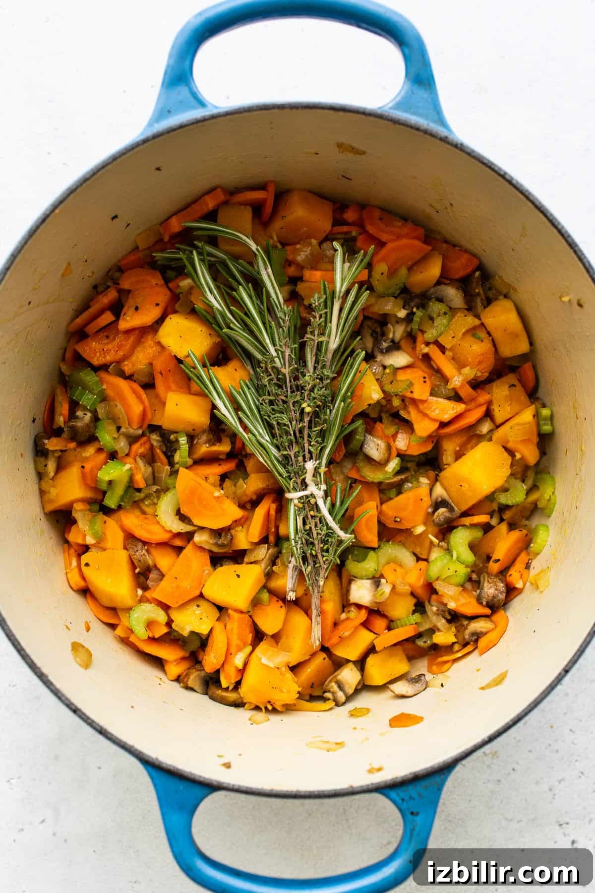 Veggies in a stock pot for turkey wild rice soup.
