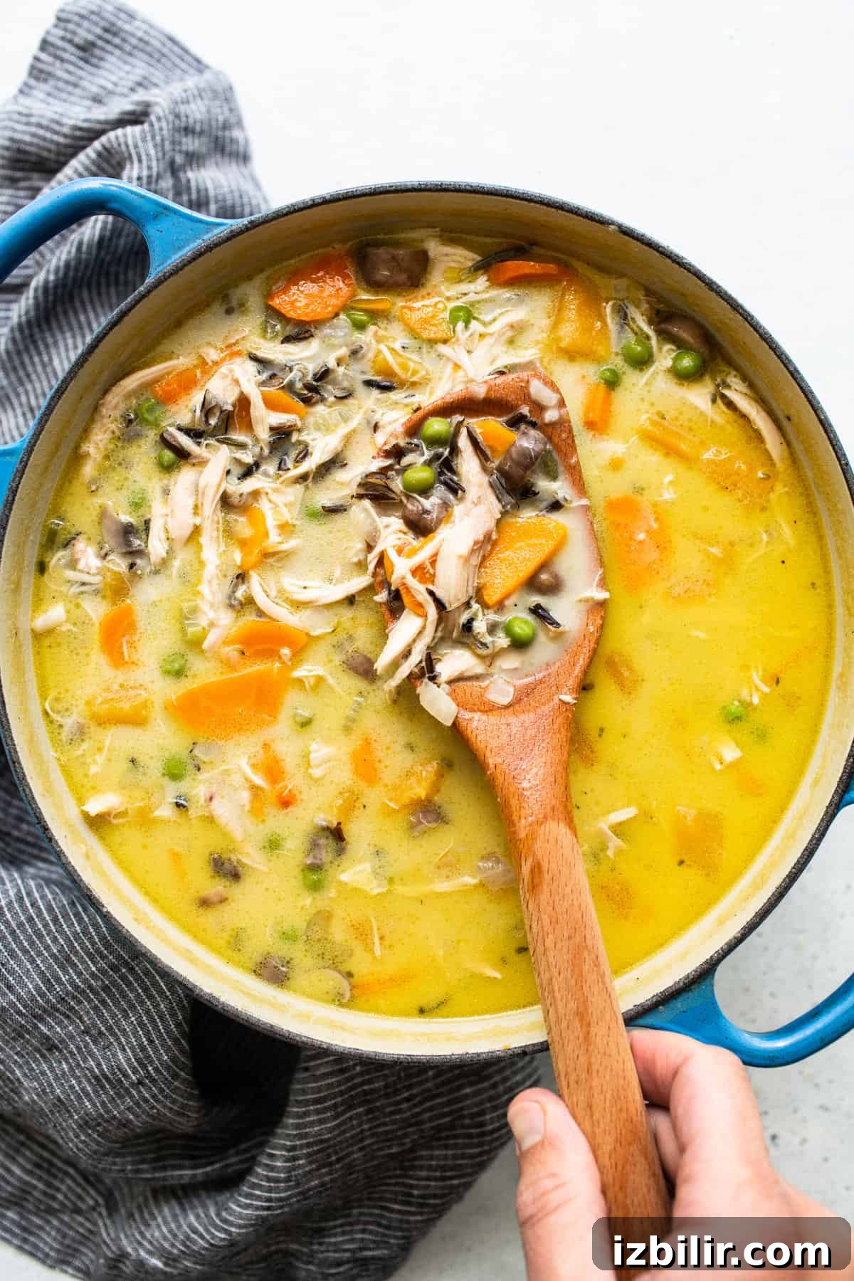 Turkey wild rice soup on a spoon.