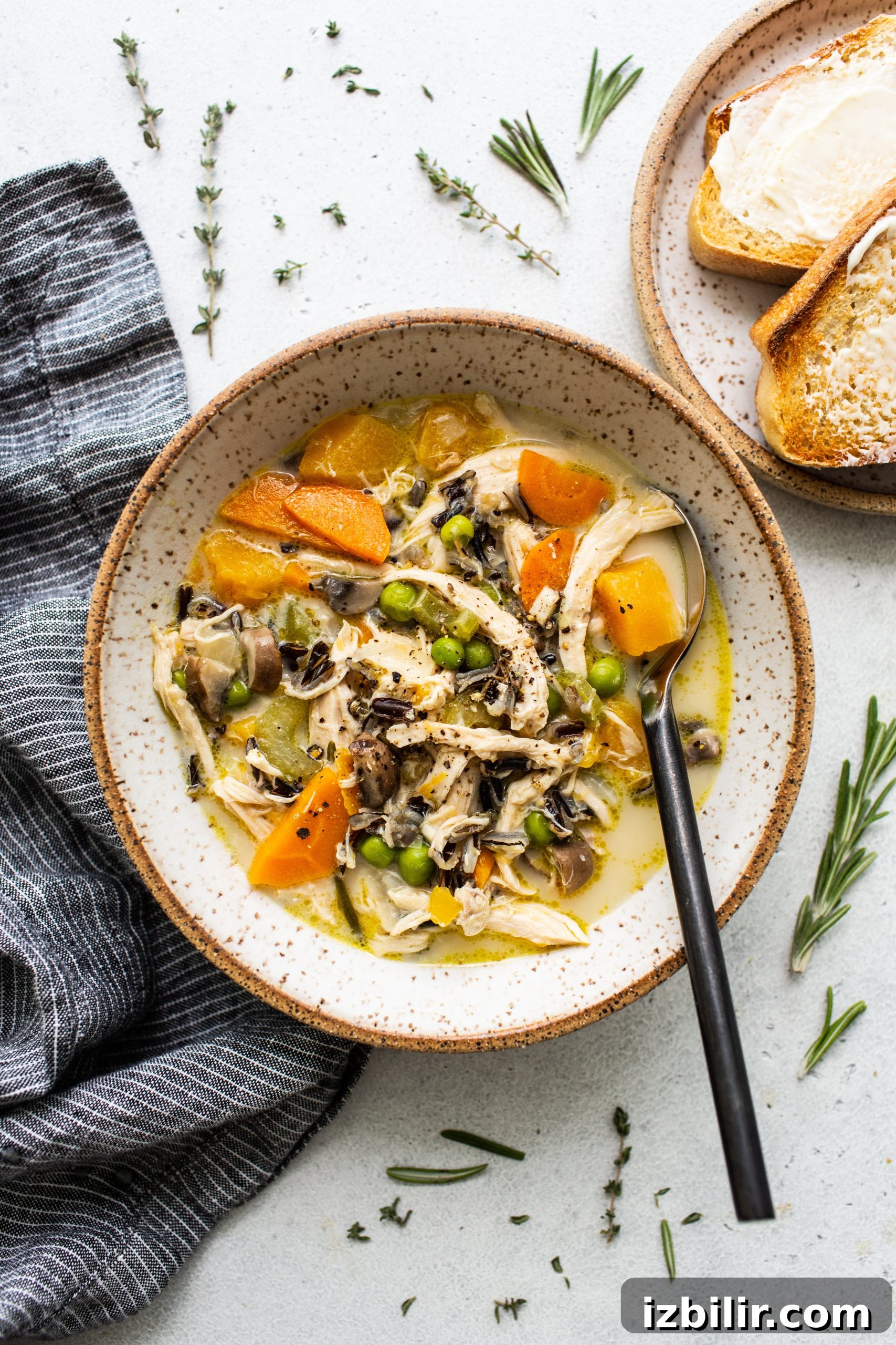 Turkey wild rice soup in a bowl with a spoon.