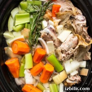 Homemade turkey broth in a crockpot.