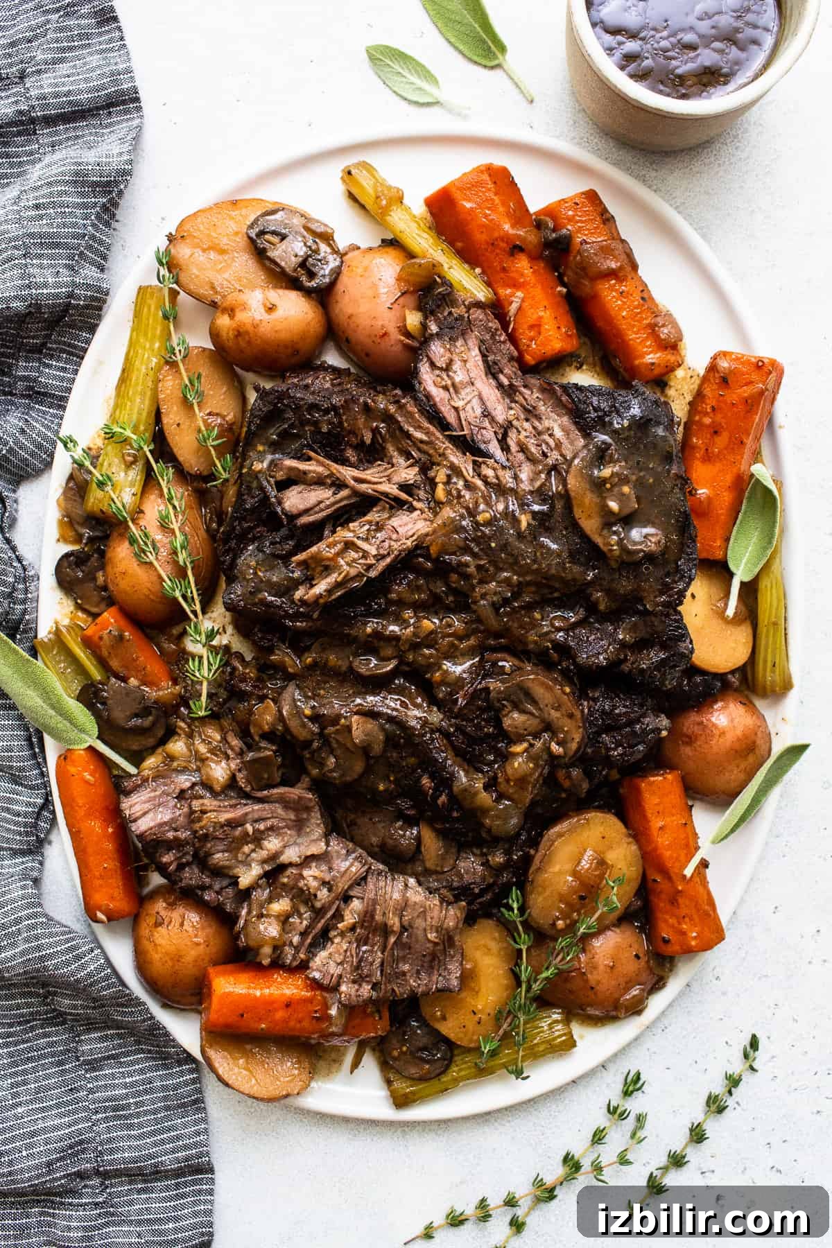 Classic braised pot roast with tender beef and root vegetables. Pot roast on a plate.