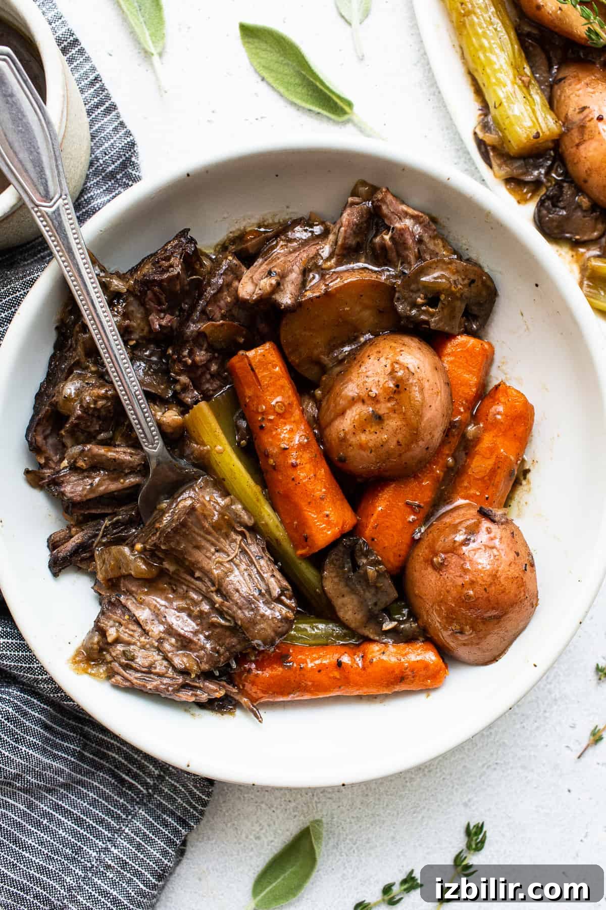 Served pot roast with tender beef and vegetables. Pot roast in a bowl with a fork.