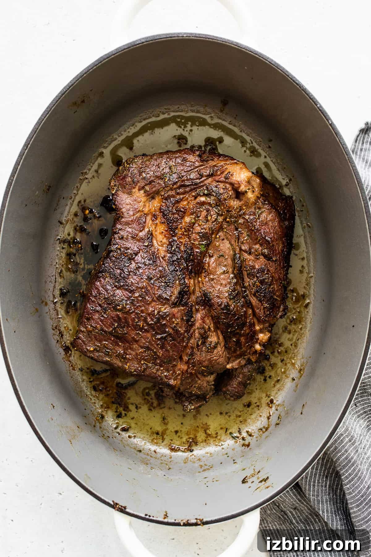 Seared chuck roast in a Dutch oven ready for braising. Seared chuck roast in a dutch oven.