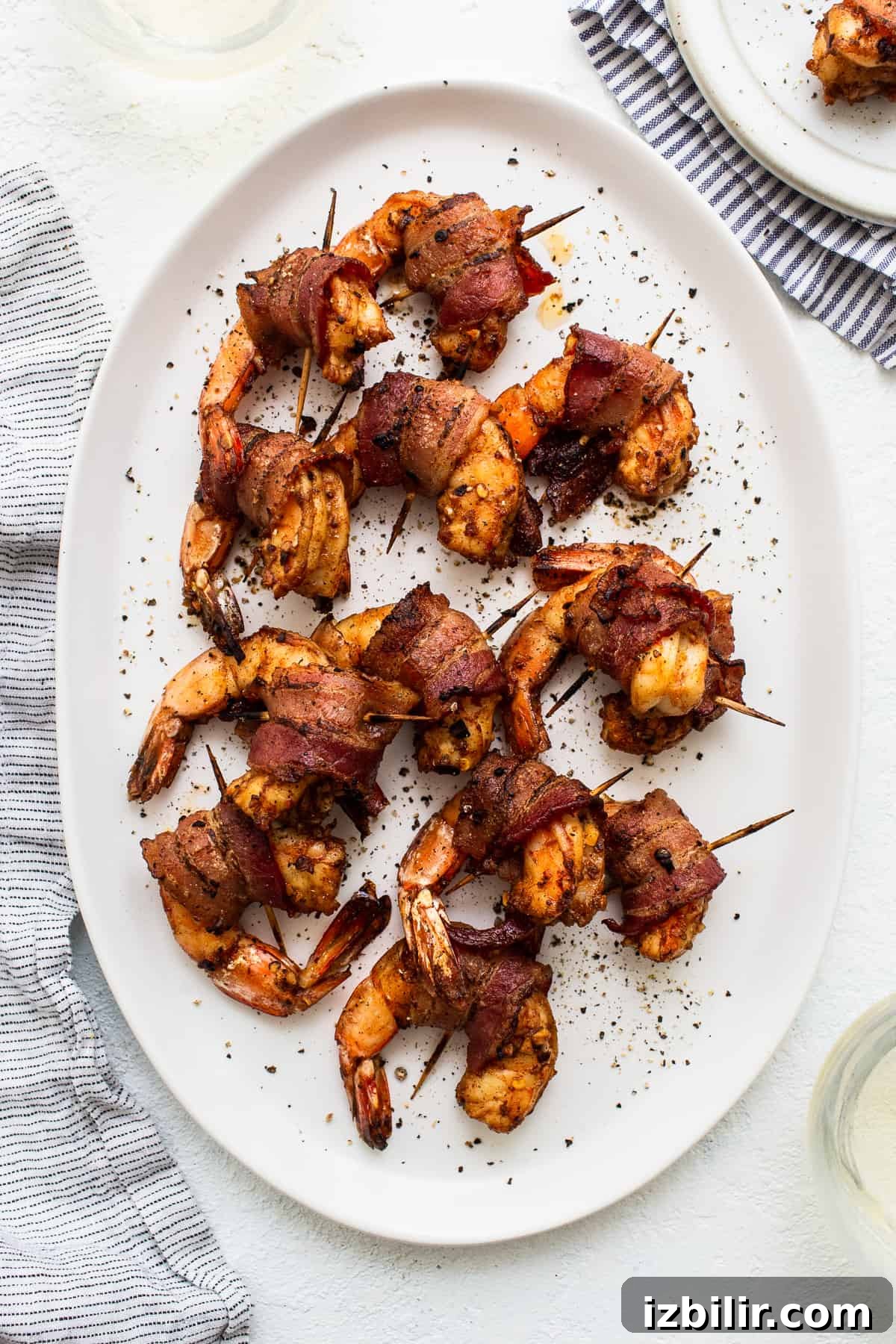 Bacon wrapped shrimp on a platter.
