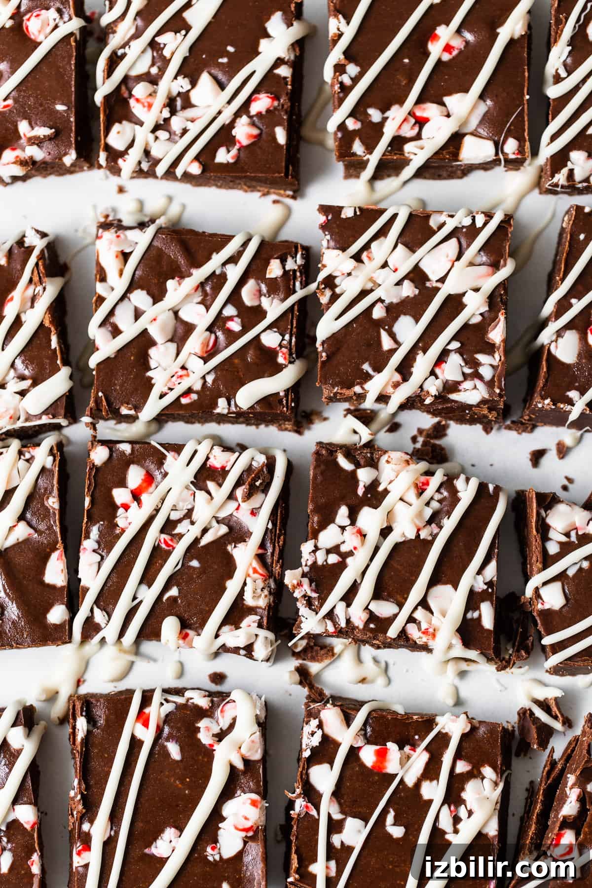 No-Bake Peppermint Freezer Fudge Recipe 8 Freezer fudge pieces with white chocolate and peppermint on top.