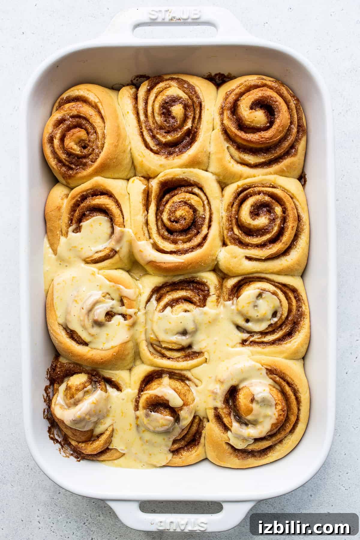 Orange-Glazed Sweet Rolls Recipe 5 Orange roll with frosting on top.