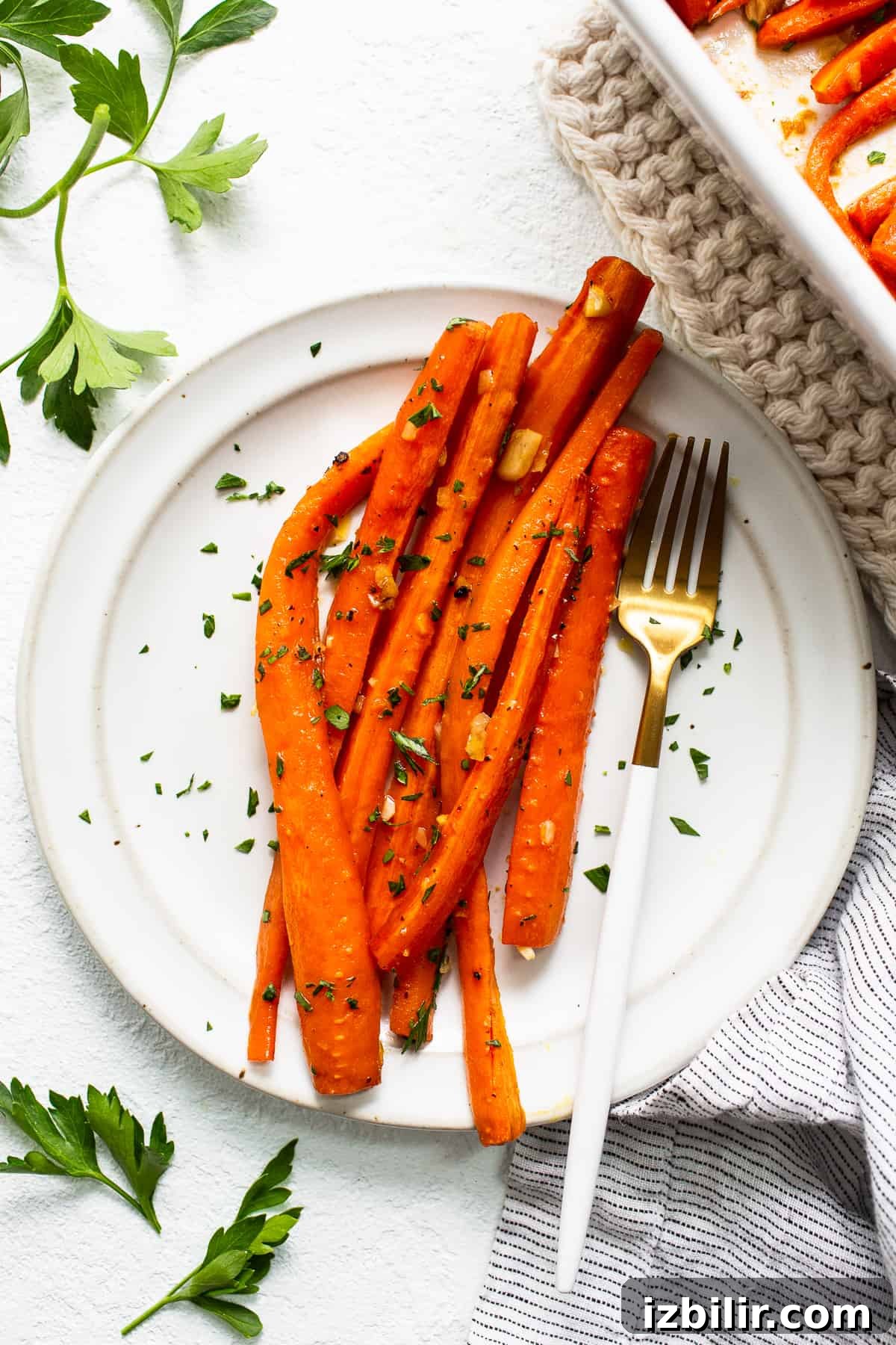 Garlic glazed carrots on a plate with a fork.