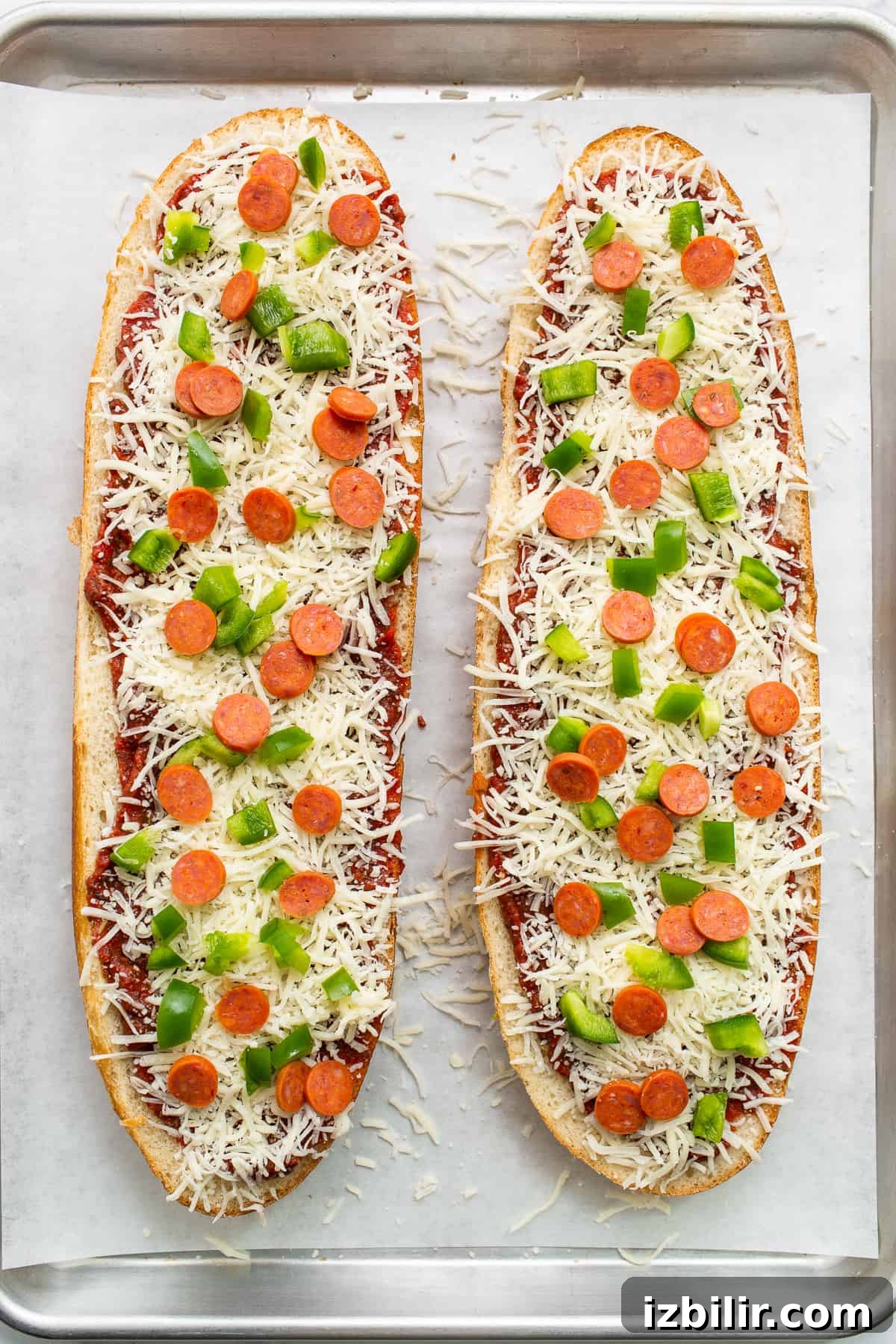 French bread pizza on a baking sheet.