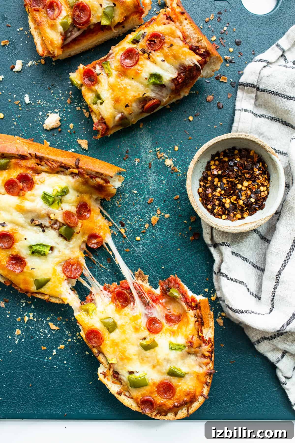 Homemade pizza slices on a cutting board.