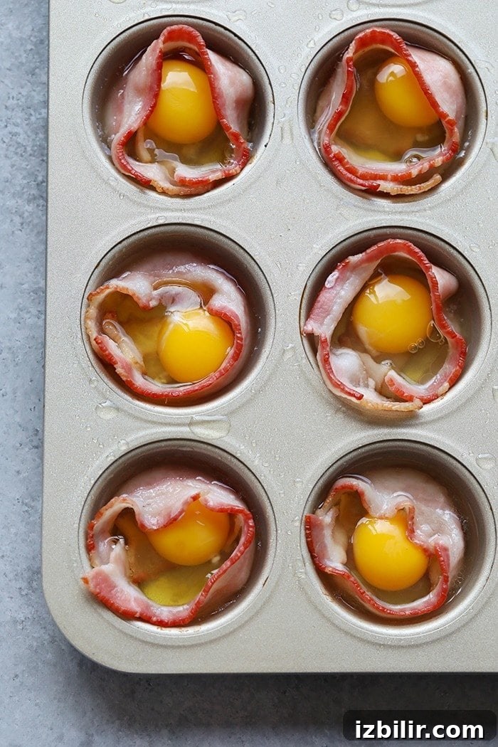 15+ Egg Breakfast Recipes to Elevate Your Morning 11 cracking raw eggs into the middle of bacon