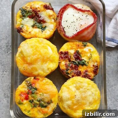 15+ Egg Breakfast Recipes to Elevate Your Morning 7 Breakfast egg cups baked in a glass dish.