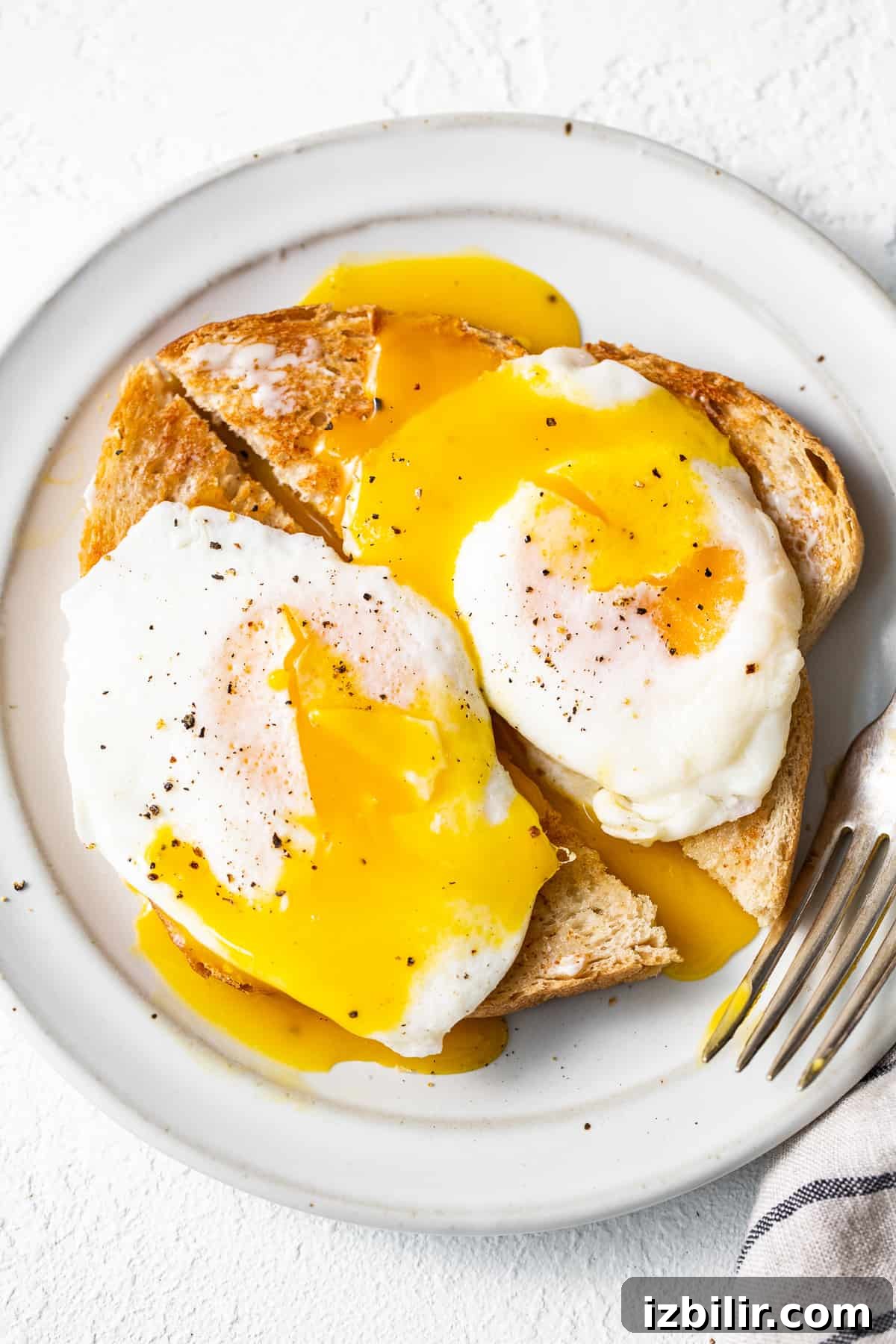 This over easy eggs recipe uses a simple technique that creates the perfect runny yolk and fluffy egg whites every time. Over easy eggs served over toast.