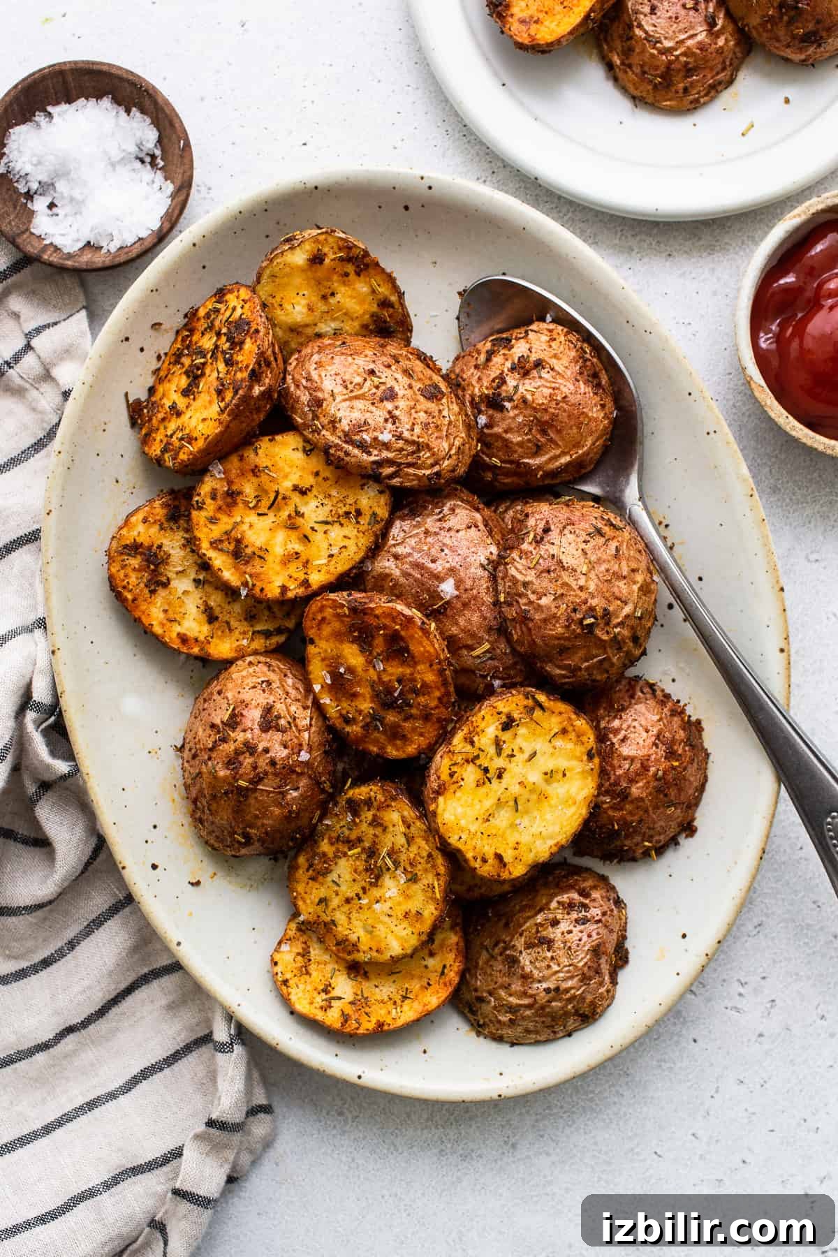 Air fryer potatoes on a plate with a spoon.