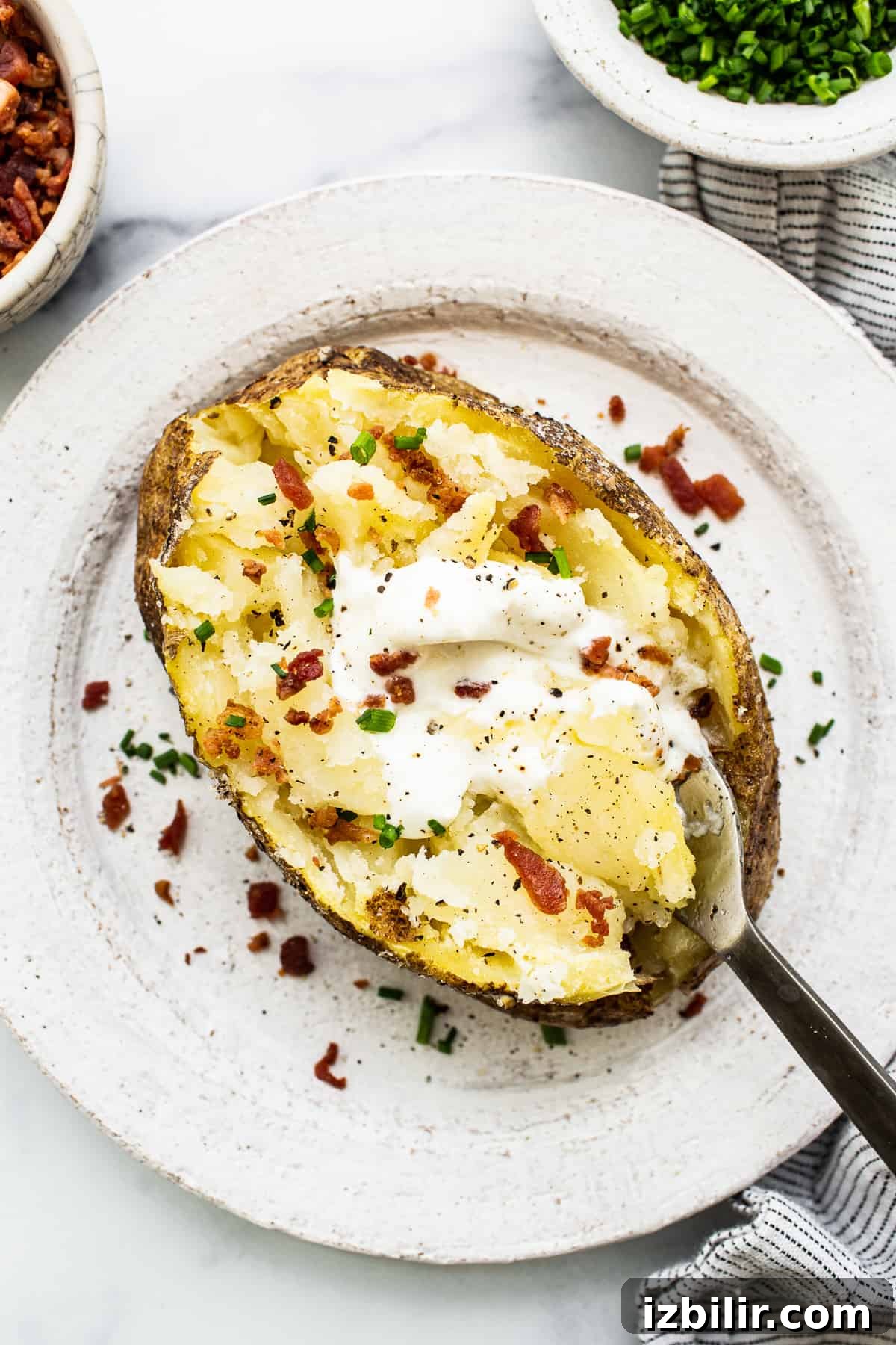 How to Make a Microwave Baked Potato 2 Microwave baked potato with toppings.