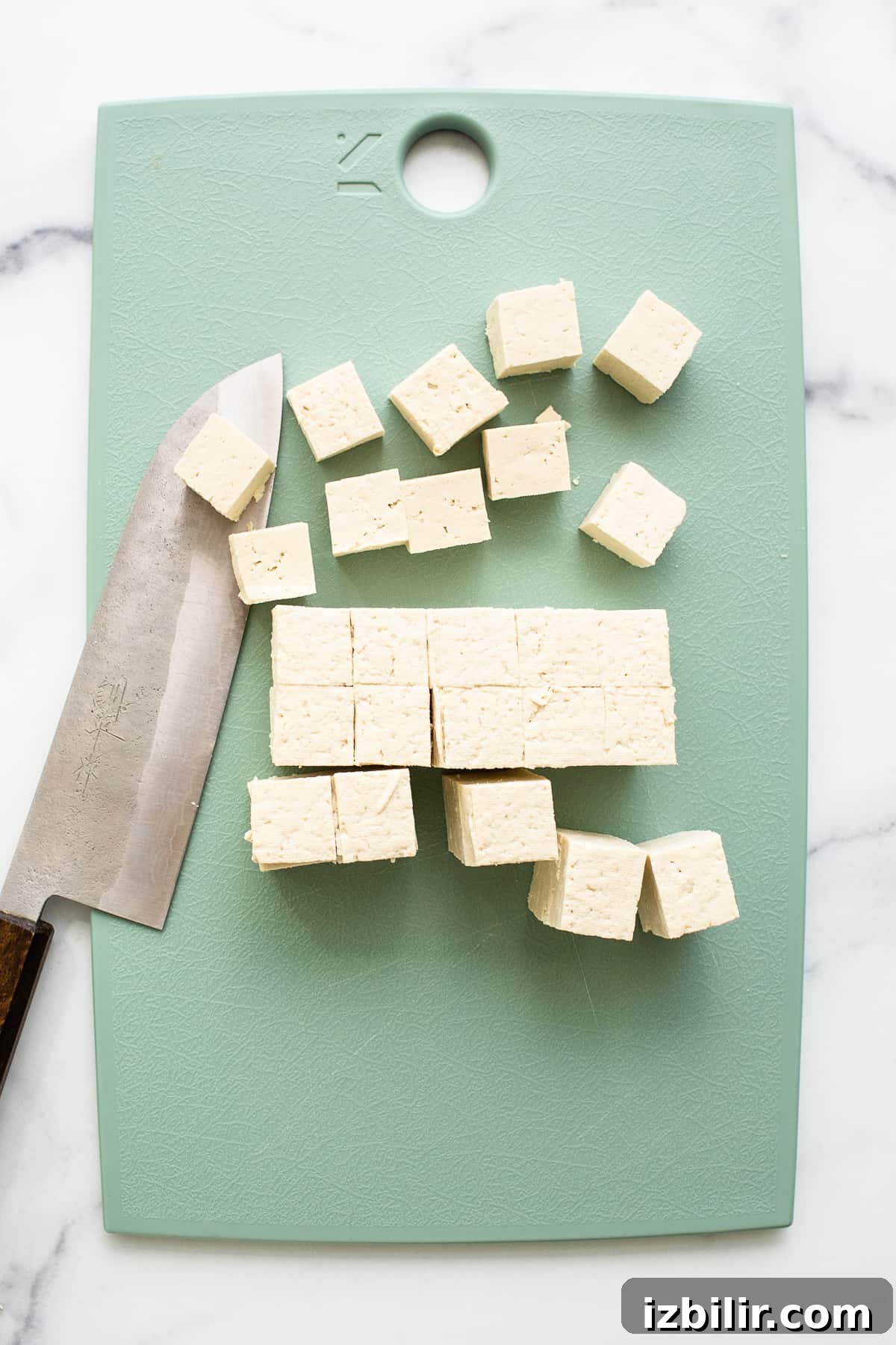 Slicing the tofu into cubes.