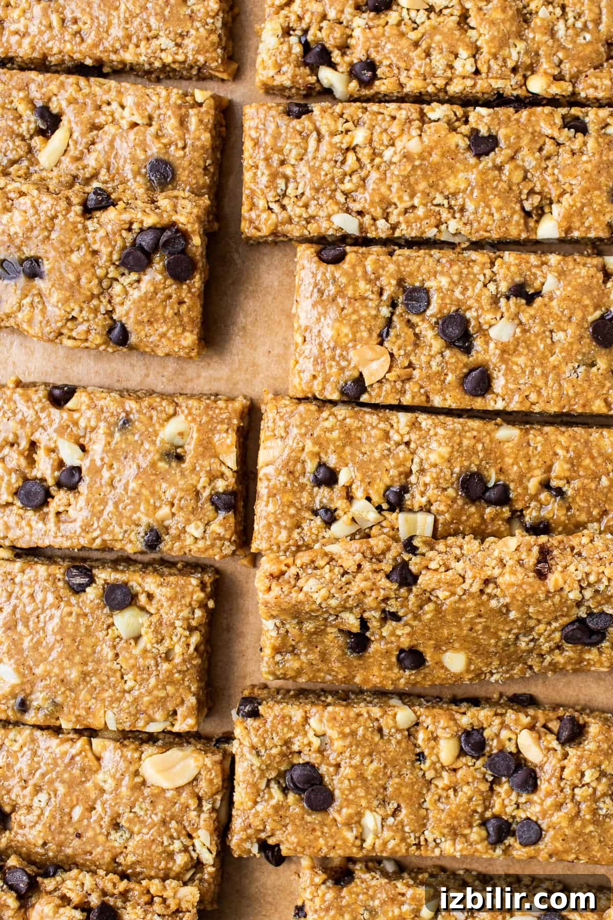No-bake peanut butter bars on parchment paper. No bake peanut butter bars cut on parchment paper.
