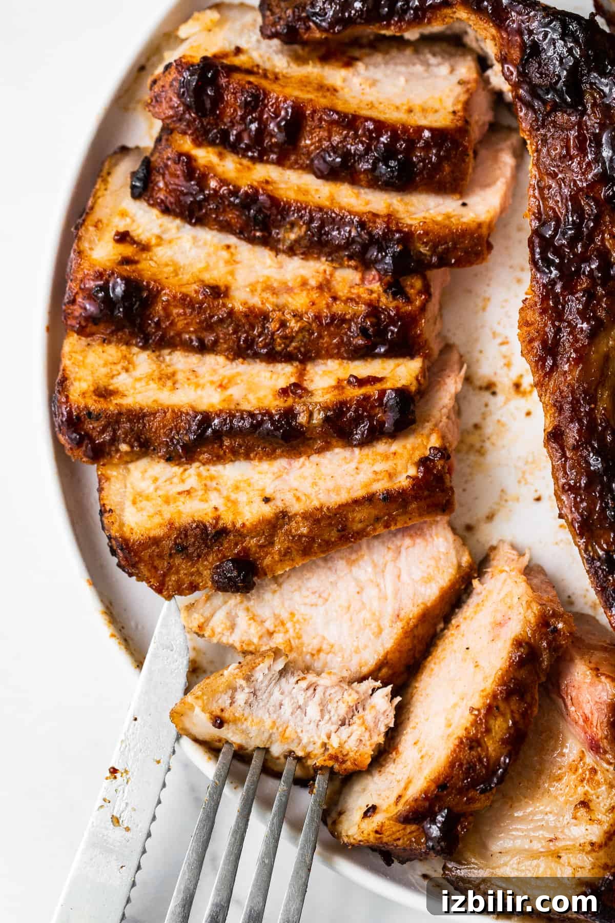 Sliced pork chops on a plate.