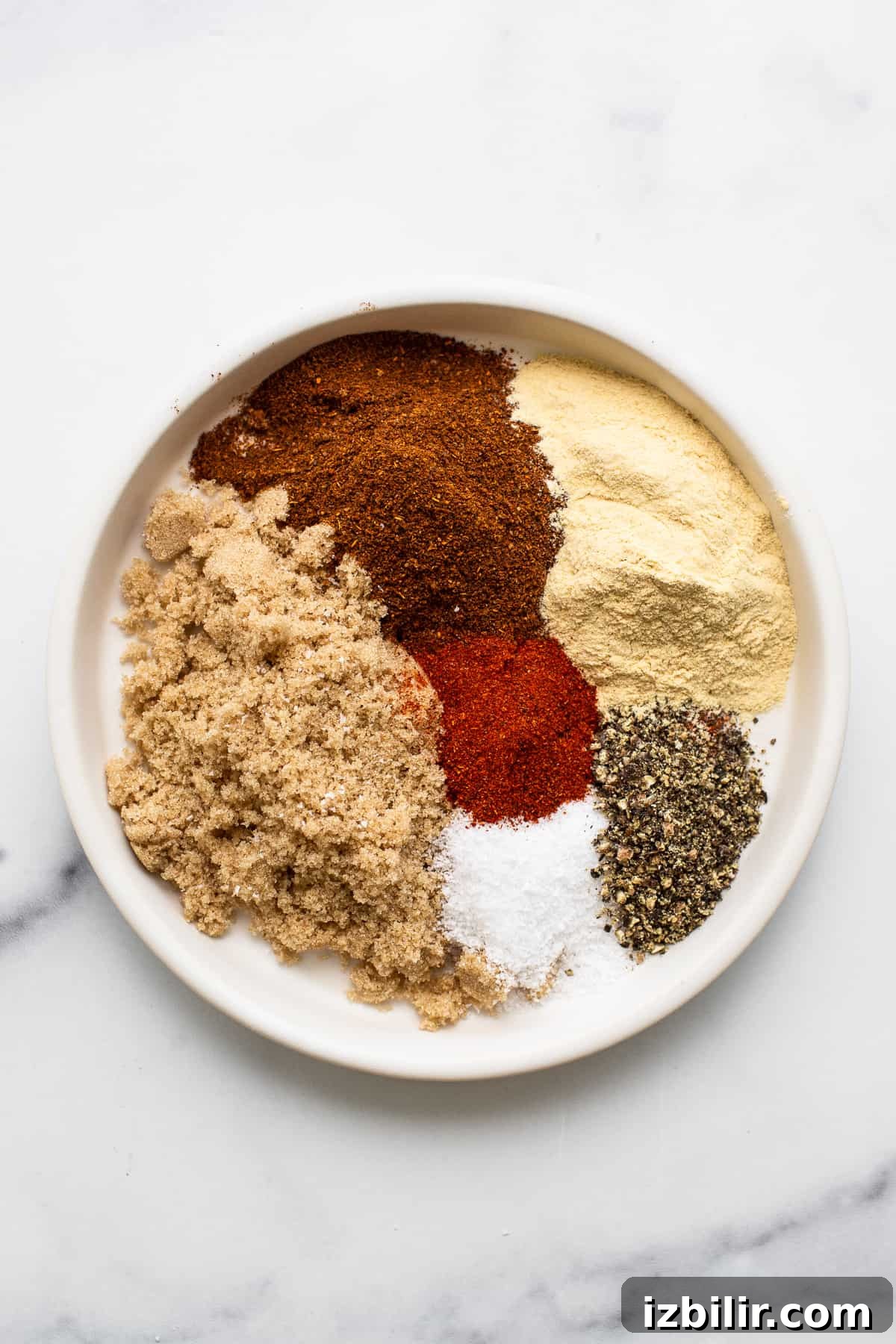Ingredients for pork chops dry rub on a plate.