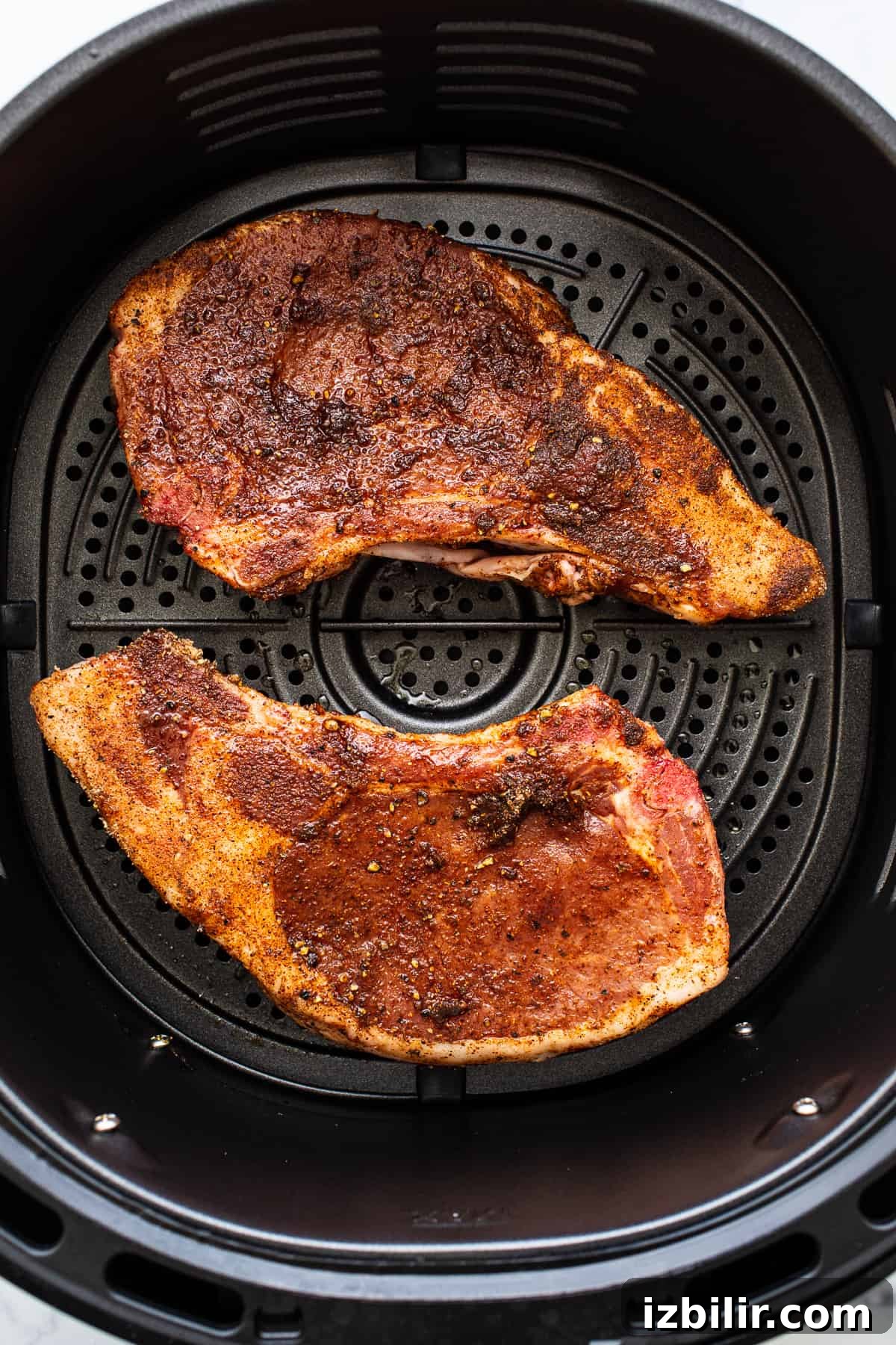 Pork chops in an air fryer.