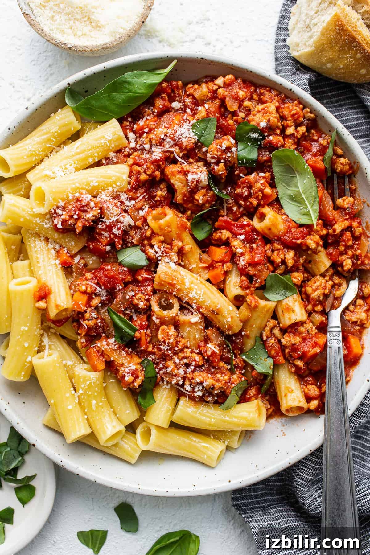 Bolognese plated over pasta Ground chicken bolognese served over pasta.