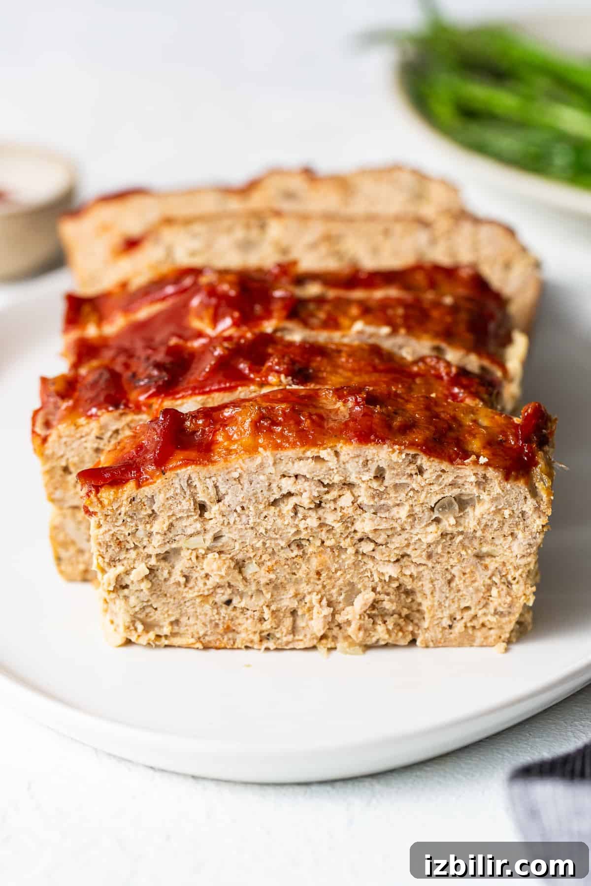 Ground turkey meatloaf sliced on a plate.