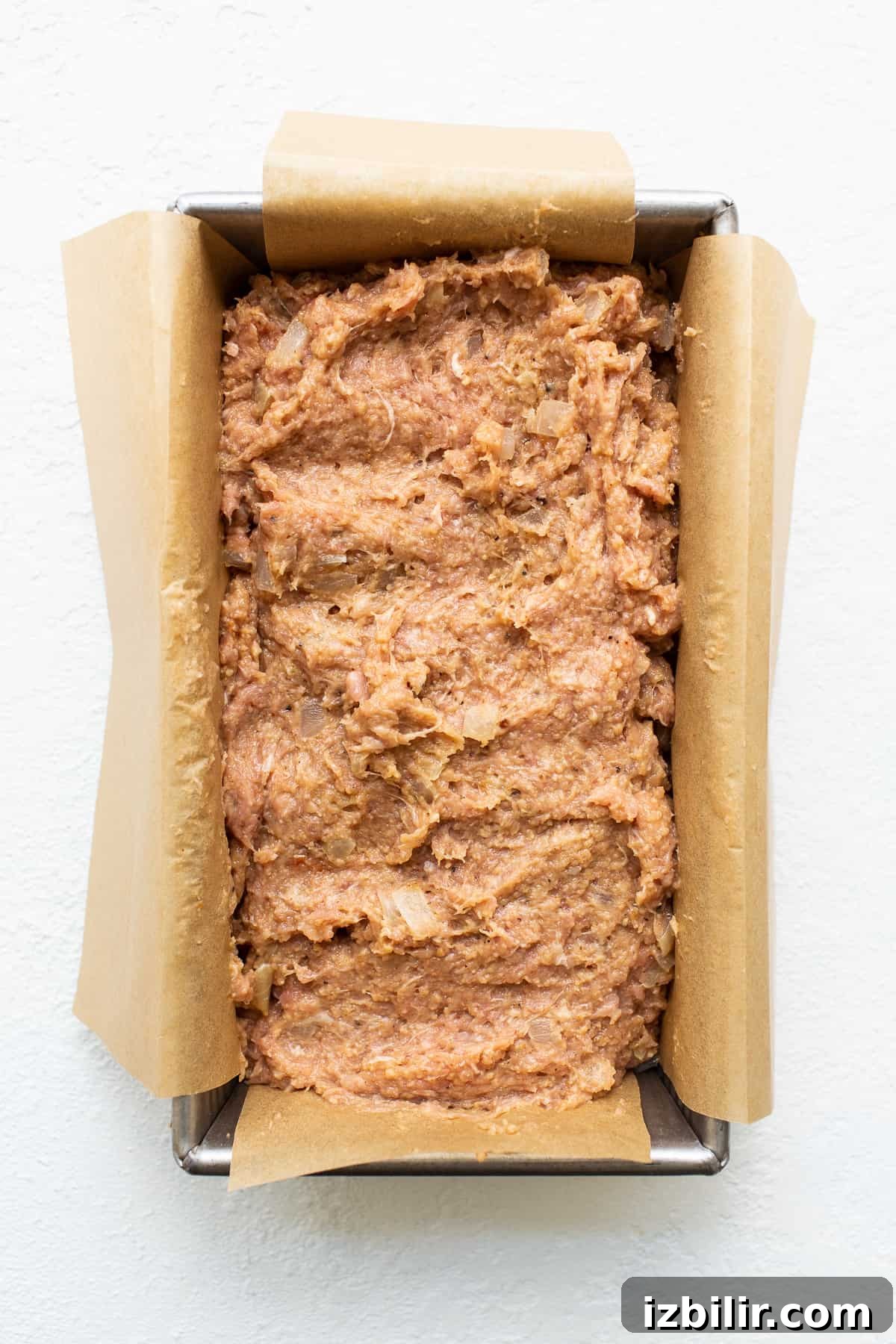 Ground turkey meatloaf in a loaf pan.