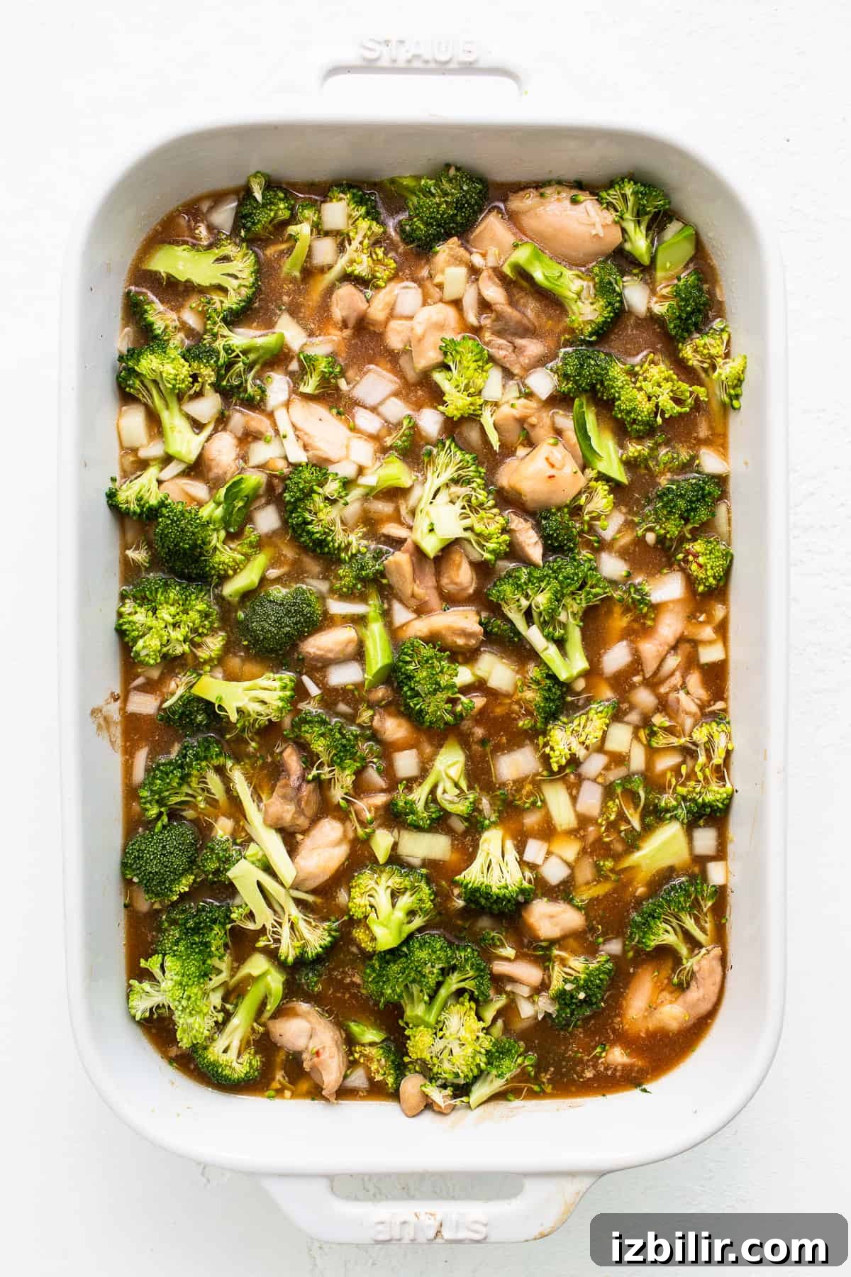 uncooked orange chicken casserole in dish.