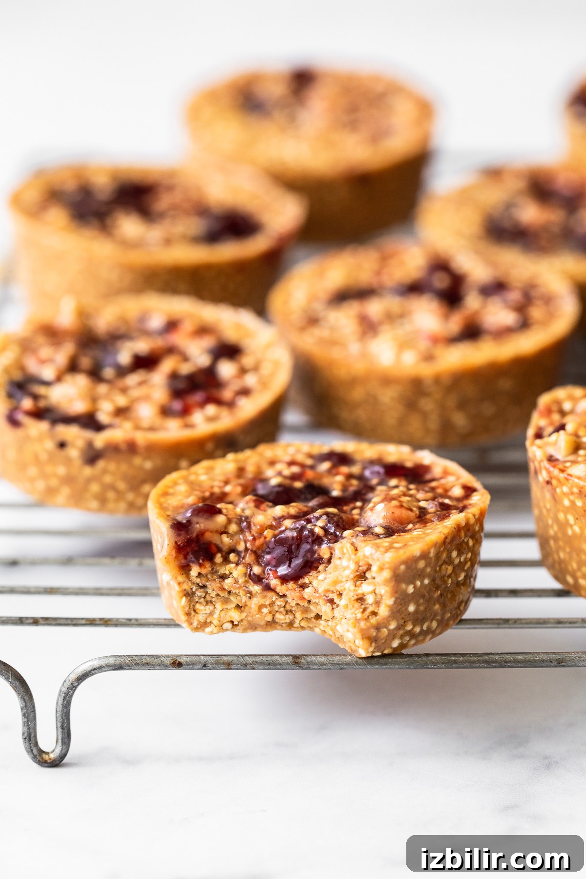 Peanut Butter and Jelly Quinoa Cups Recipe 2 Peanut butter and jelly cups on a metal rack.