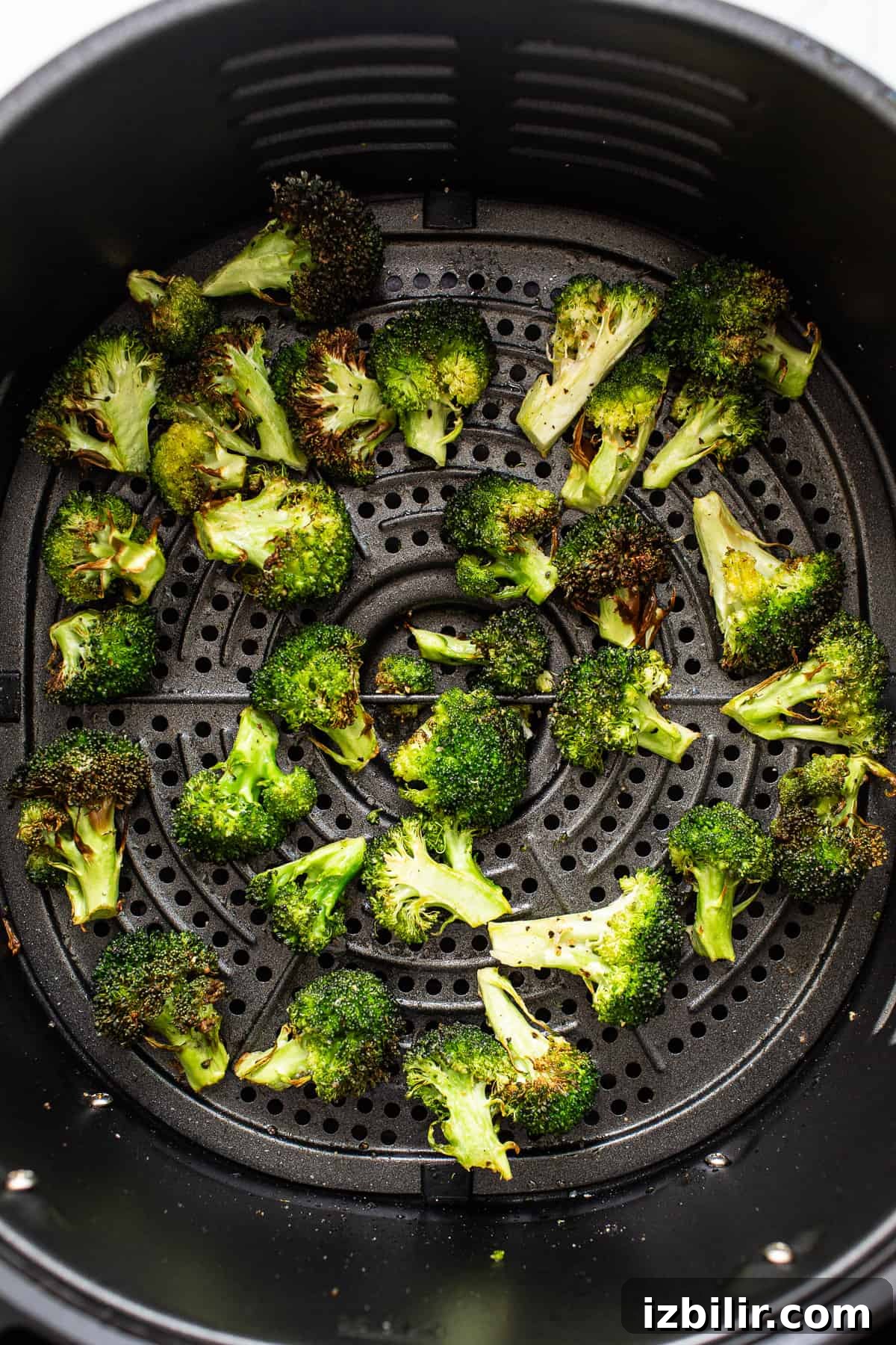 Crispy broccoli florets in an air fryer.