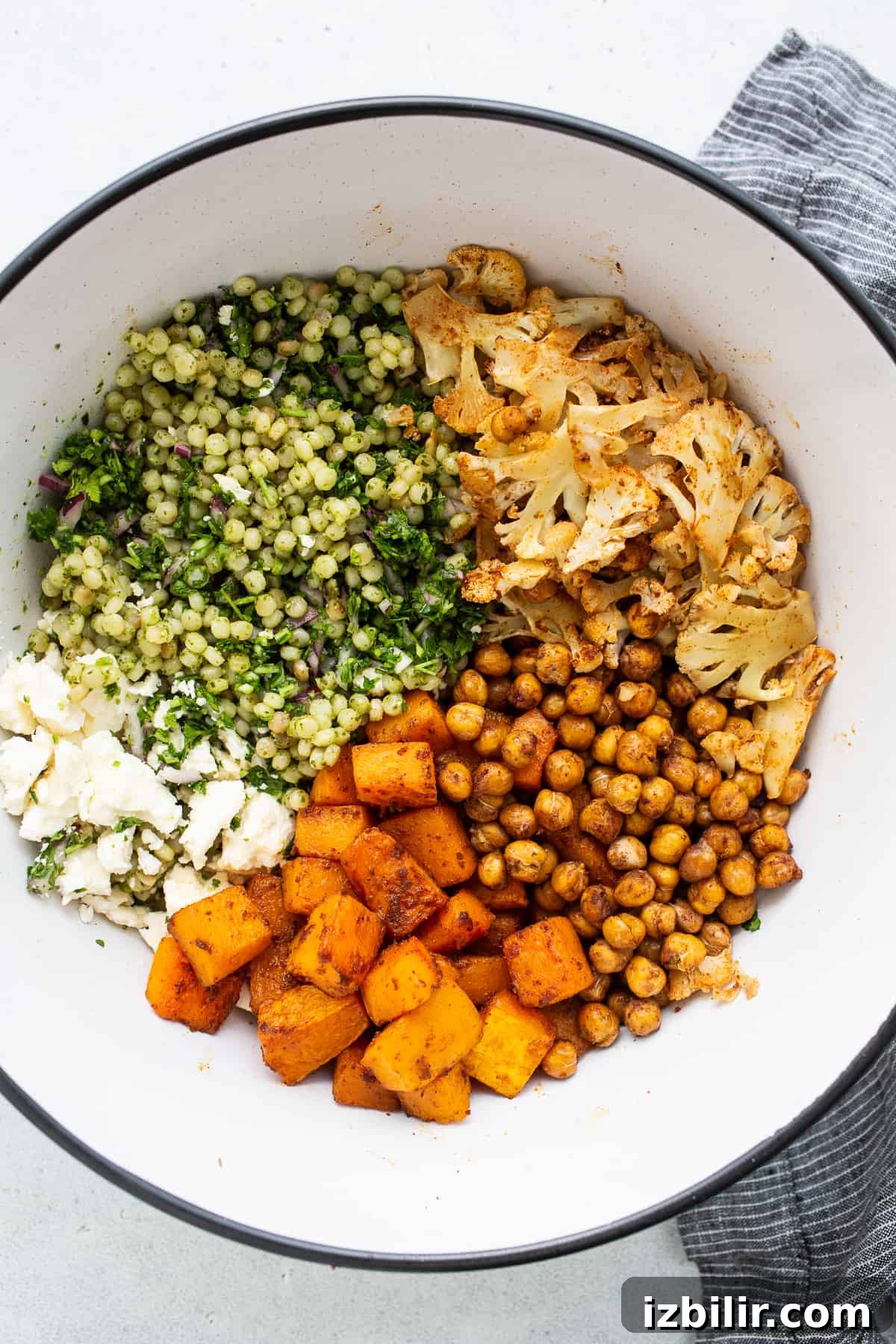 All of the ingredients for the couscous salad in a bowl.